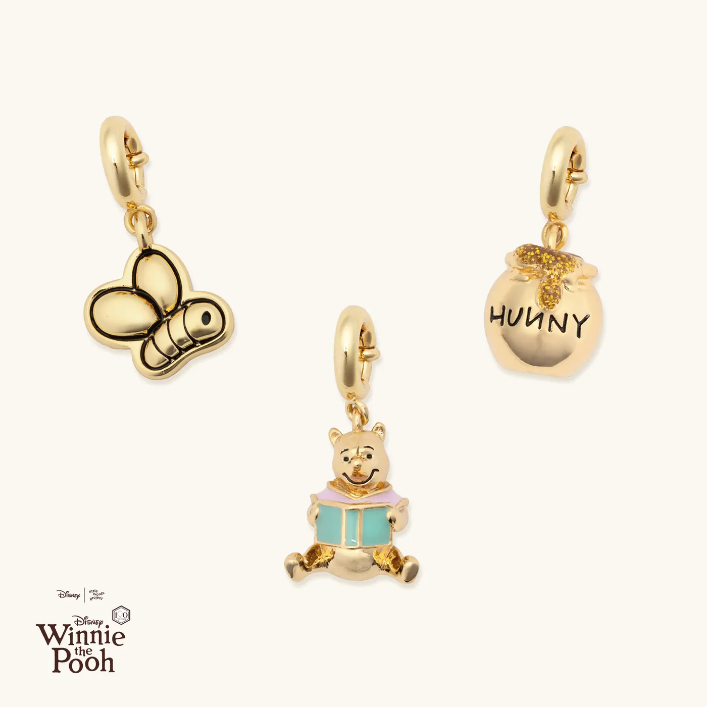 This trio of charms comes "straight from a storybook" and features three icons evocative of Pooh and his fancy-free lifestyle: a charm of Pooh's pot of "Hunny," a charm for a cute flying bee, and, of course, a charm of Pooh himself enjoying a book.