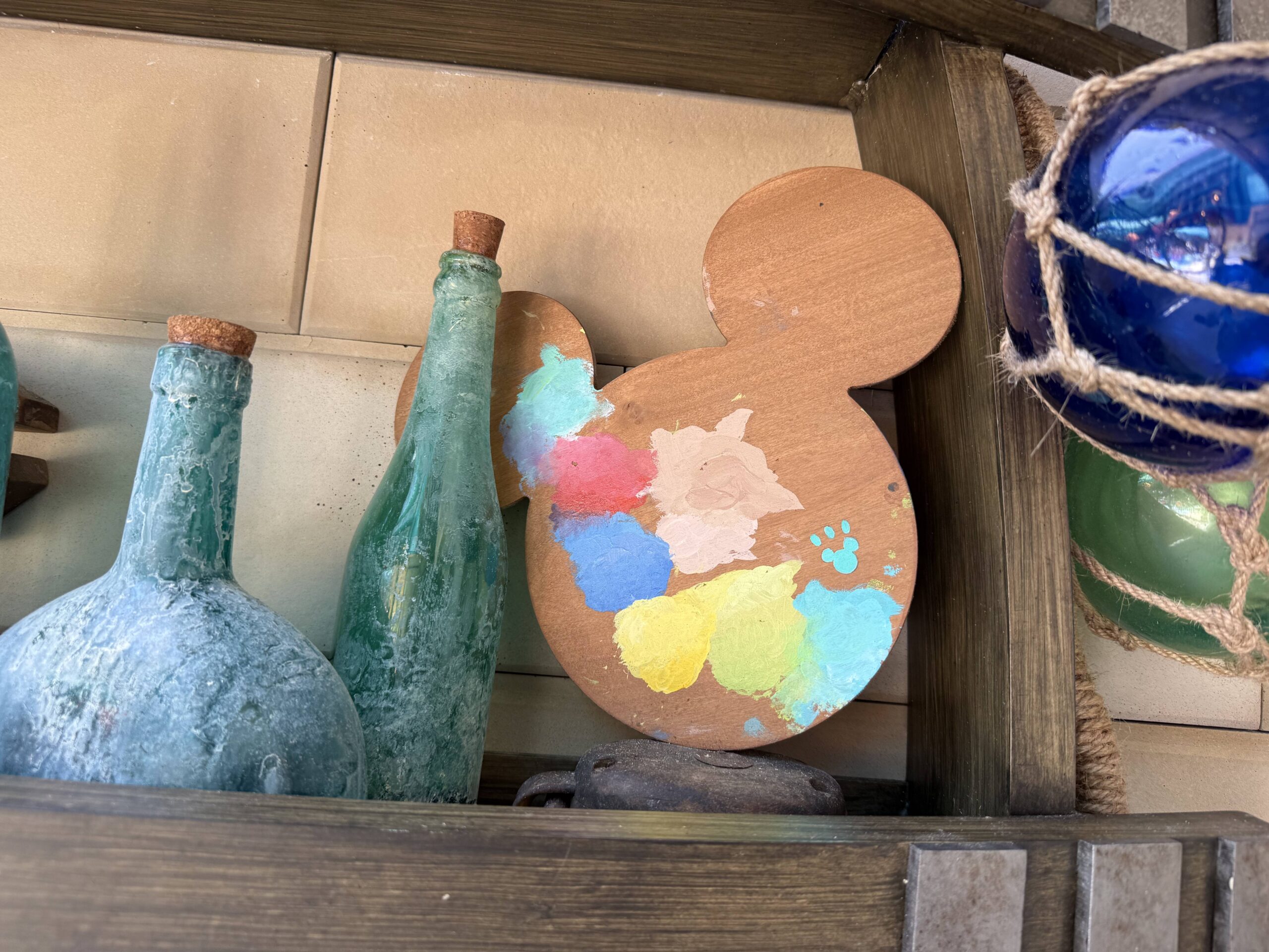 The space has many Riviera-inspired pieces of decor—including glass jars and this Mickey-shaped artist palette with a Hidden Mickey inside. You'll be able to see more decor in our YouTube video at the end of this post.