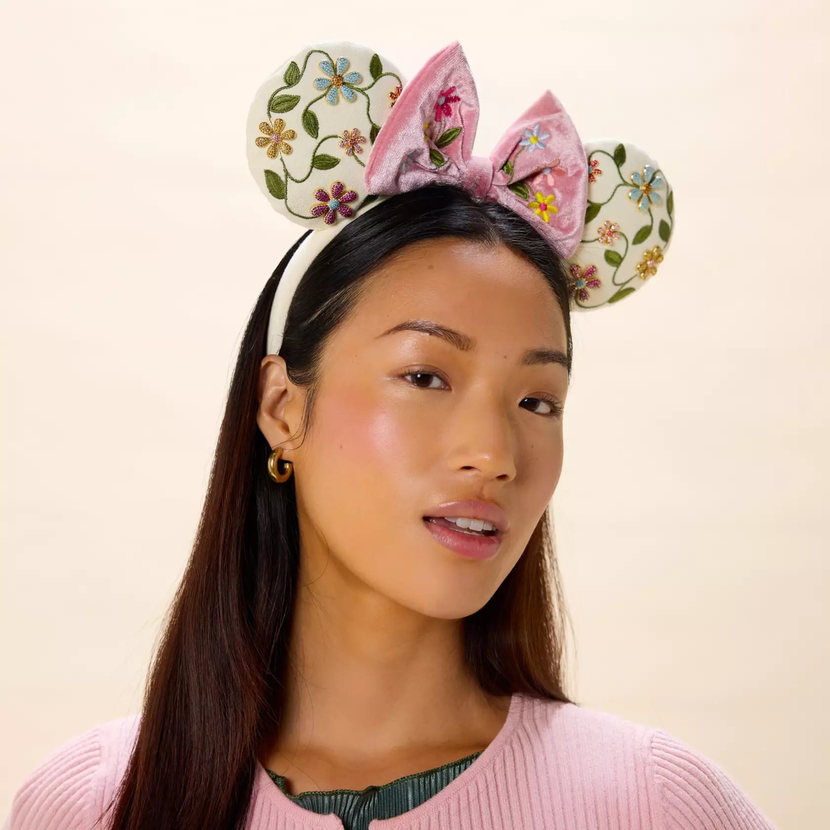 The front and back of the soft padded ears on this headband feature an embroidered floral design.