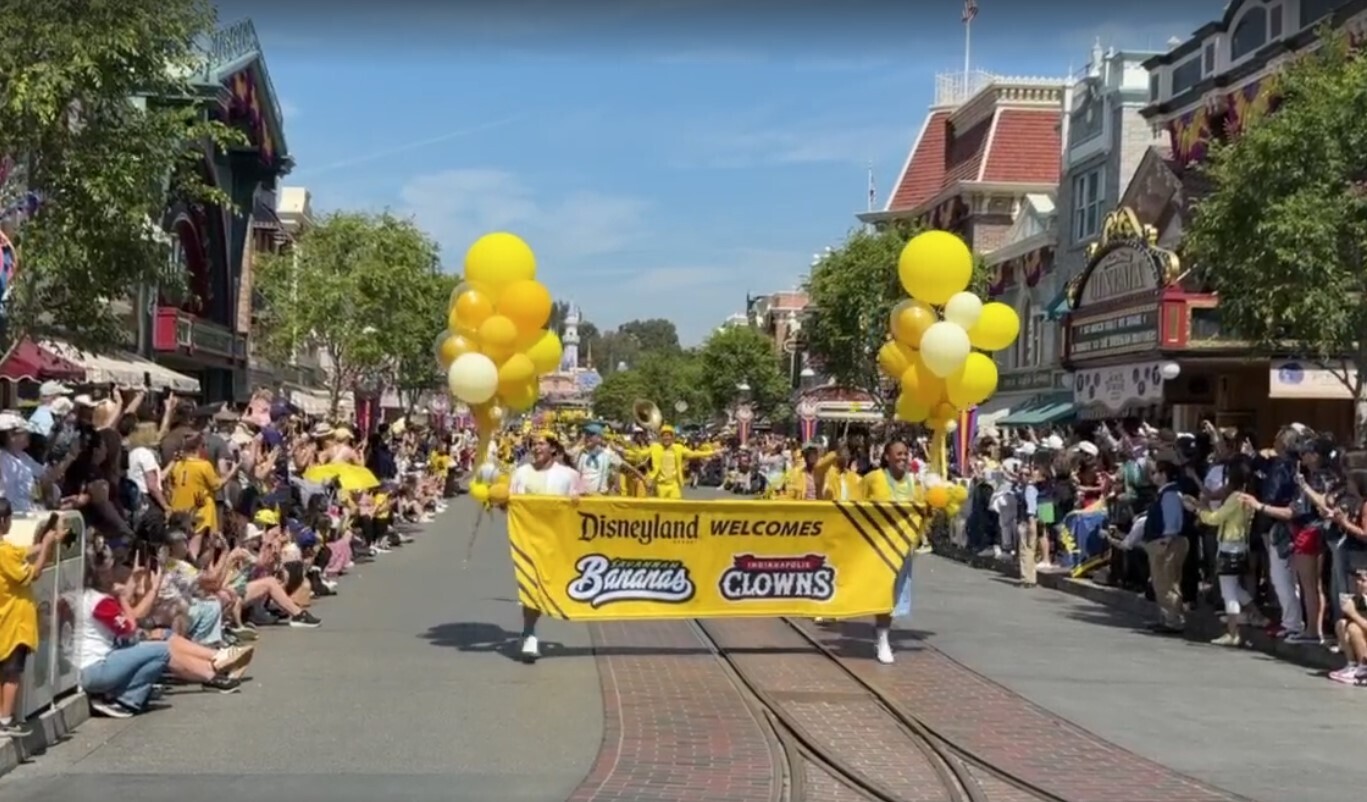 The cavalcade started with a yellow "Disneyland welcomes the Savannah Bananas and Indianapolis Clowns" banner decorated with balloons.