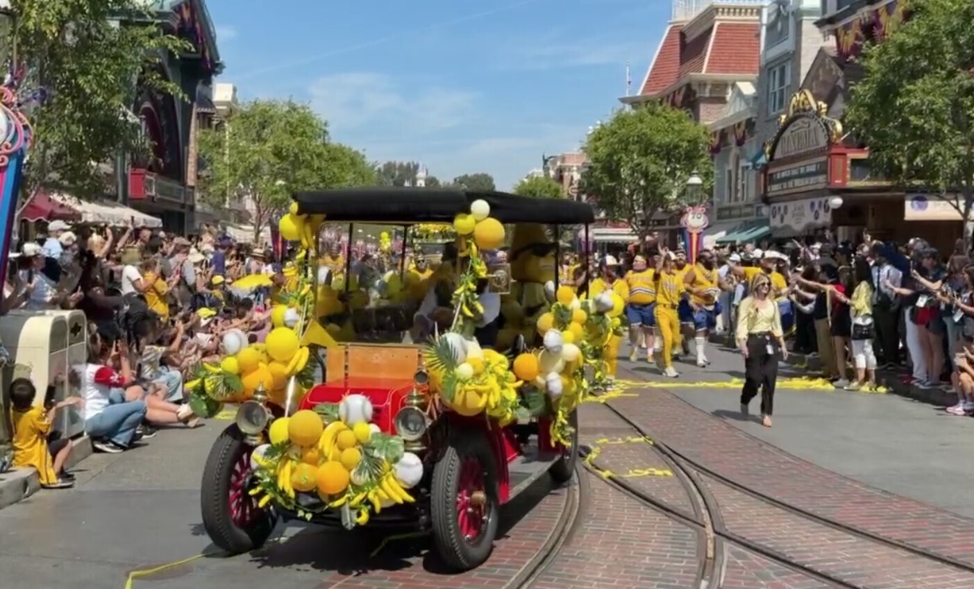 Players dressed in their yellow Savannah Bananas uniforms then walk alongside the Disneyland Fire Engine.