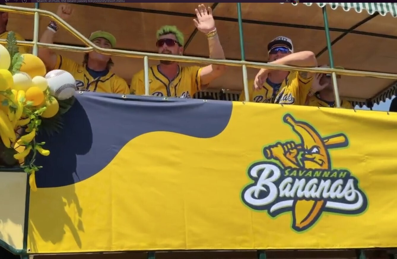 The cavalcade concludes with players waving and cheering from the Disneyland Omnibus while players from the Indianapolis Clowns walk behind them.