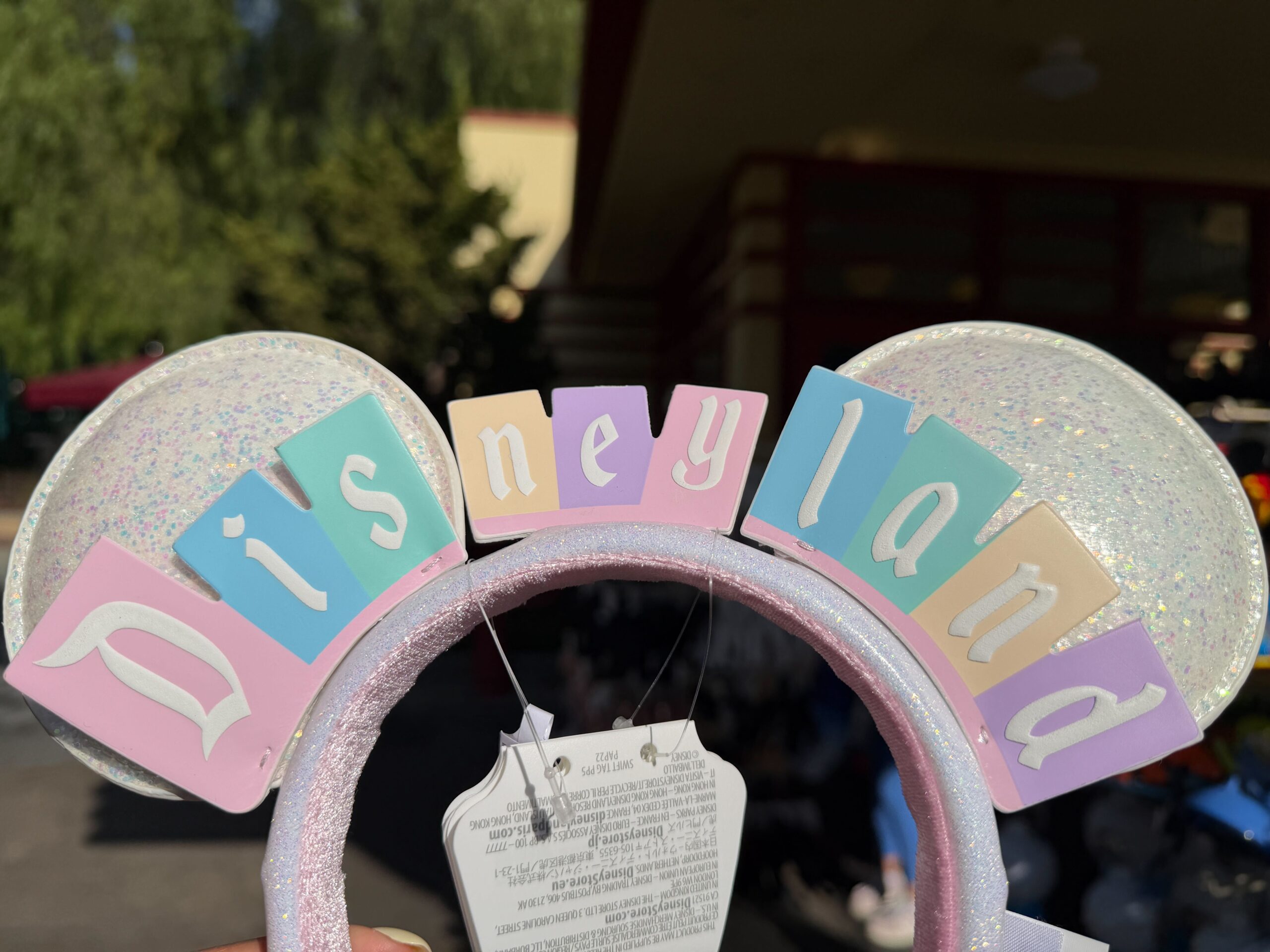 A new ear headband features the vintage Disneyland marquee sign in pastel colors.