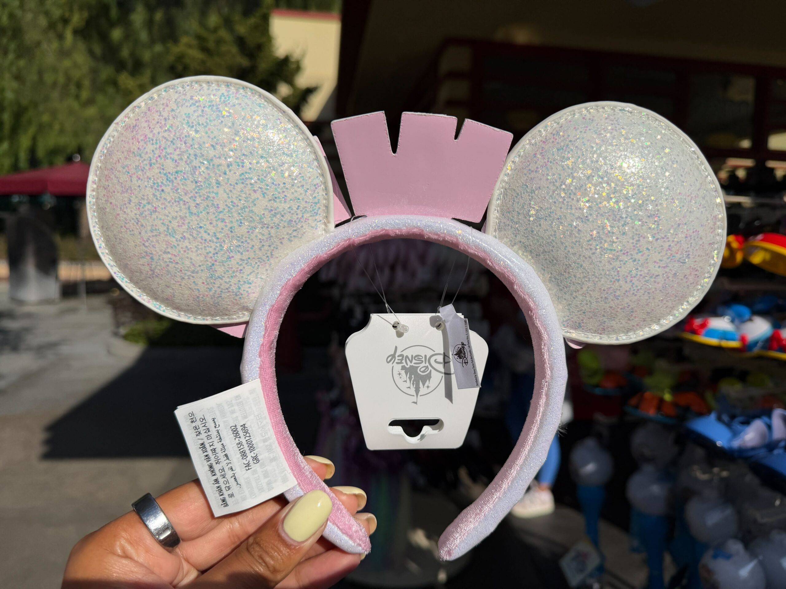 A new ear headband features the vintage Disneyland marquee sign in pastel colors.