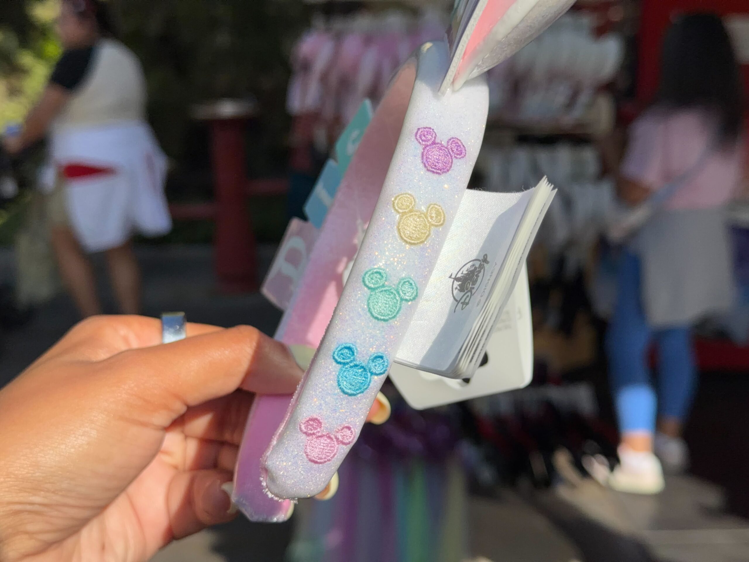 A new ear headband features the vintage Disneyland marquee sign in pastel colors.