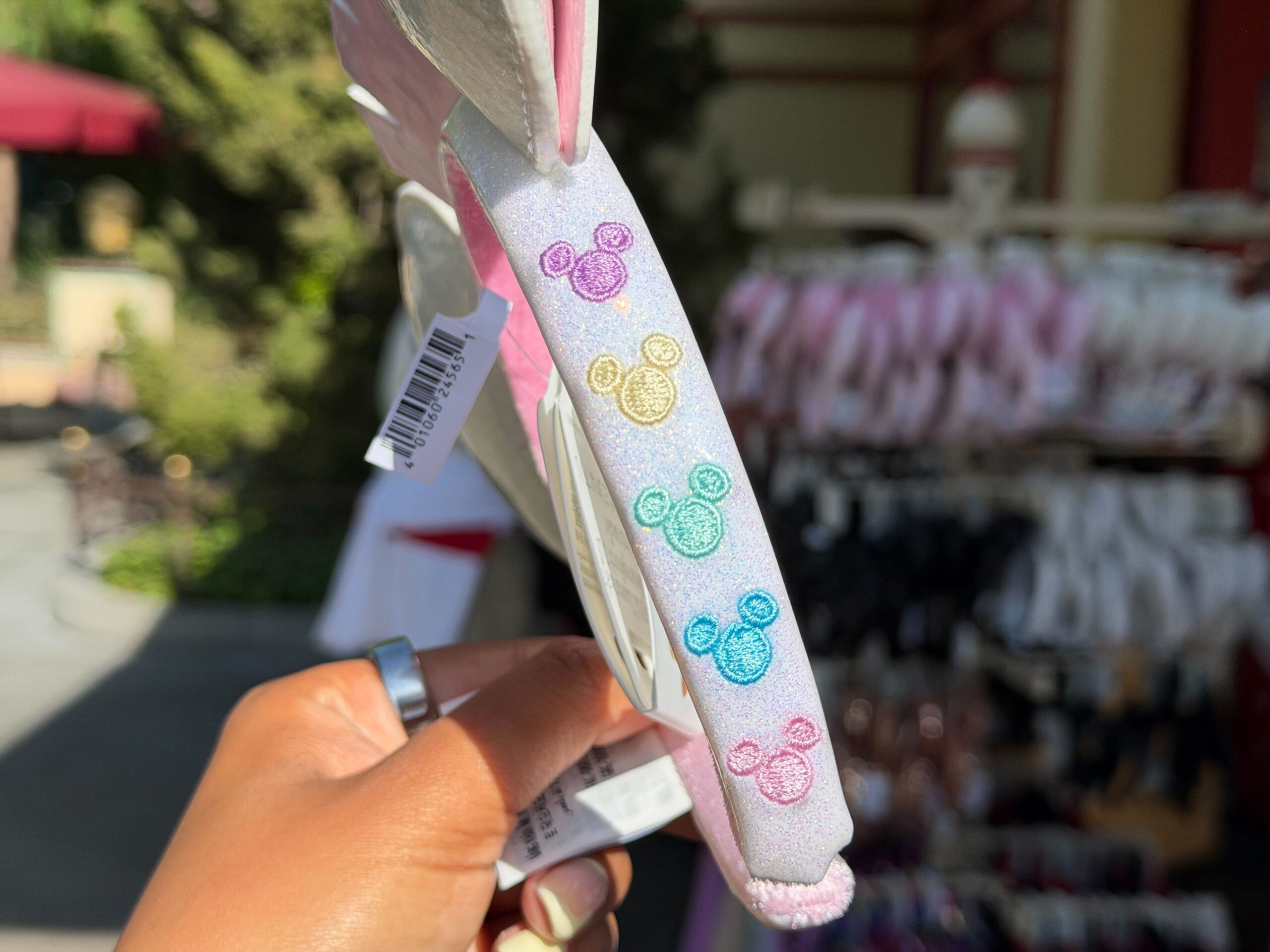 A new ear headband features the vintage Disneyland marquee sign in pastel colors.