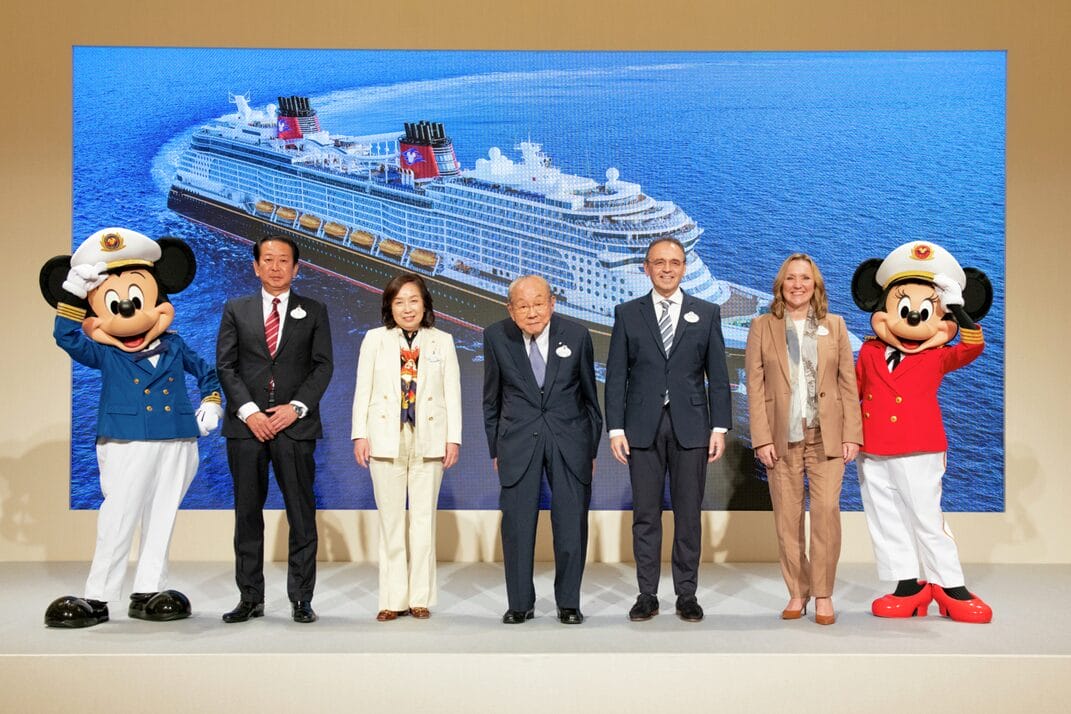 Captains Mickey and Minnie flank members of the Oriental Land Company board as they announce their new cruise ship