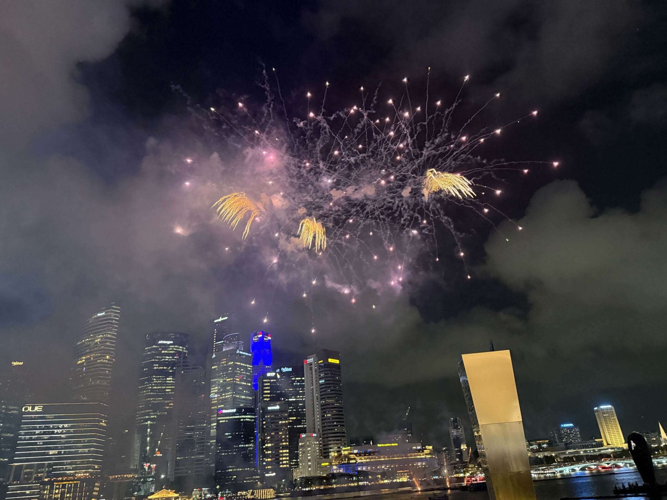 Then a barrage of fireworks in whites and pinks explodes in the sky above the city's skyscrapers.