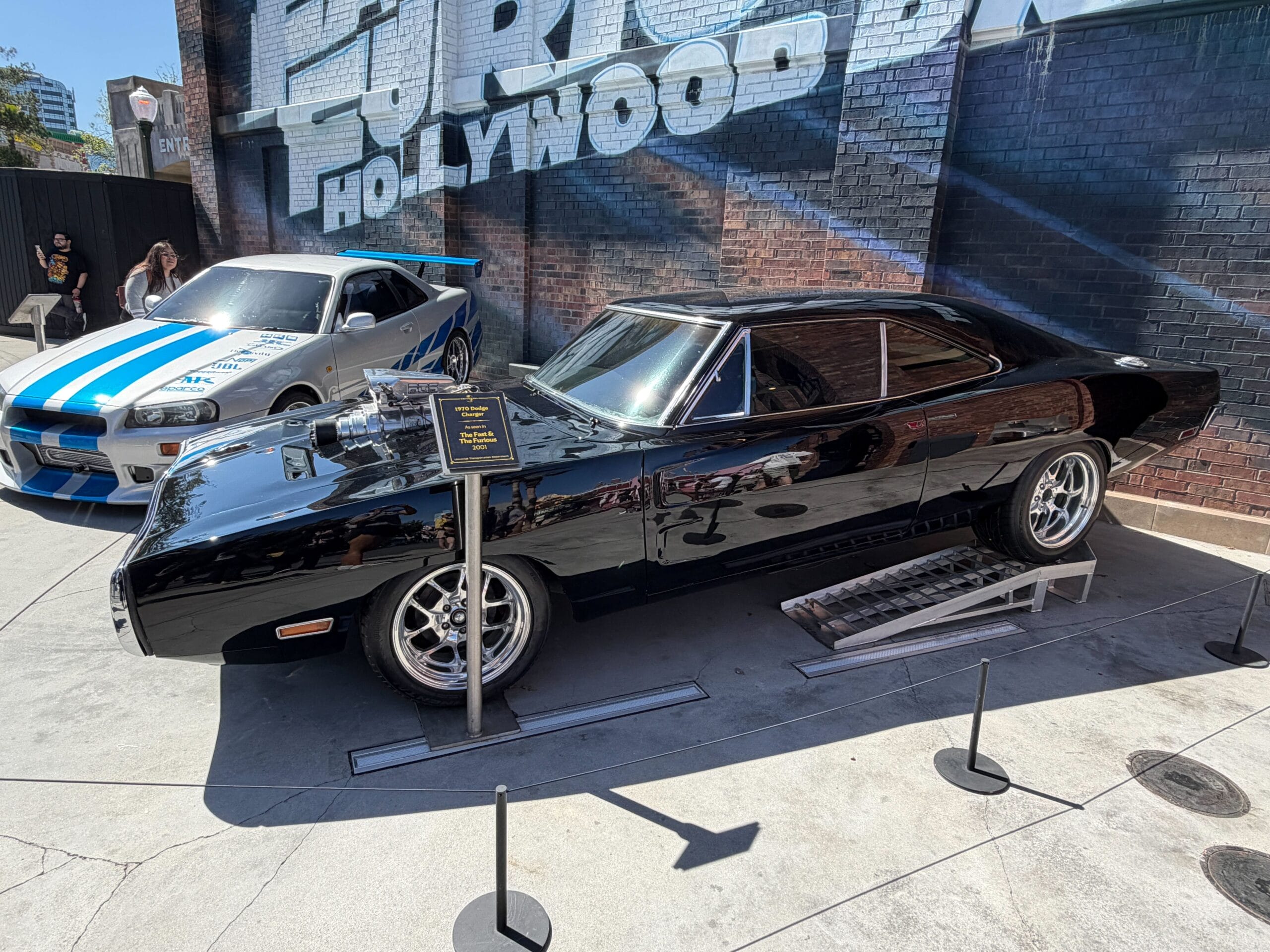 The car on the right is a black 1970 Dodge Charger from the 2001 original film, The Fast & the Furious.