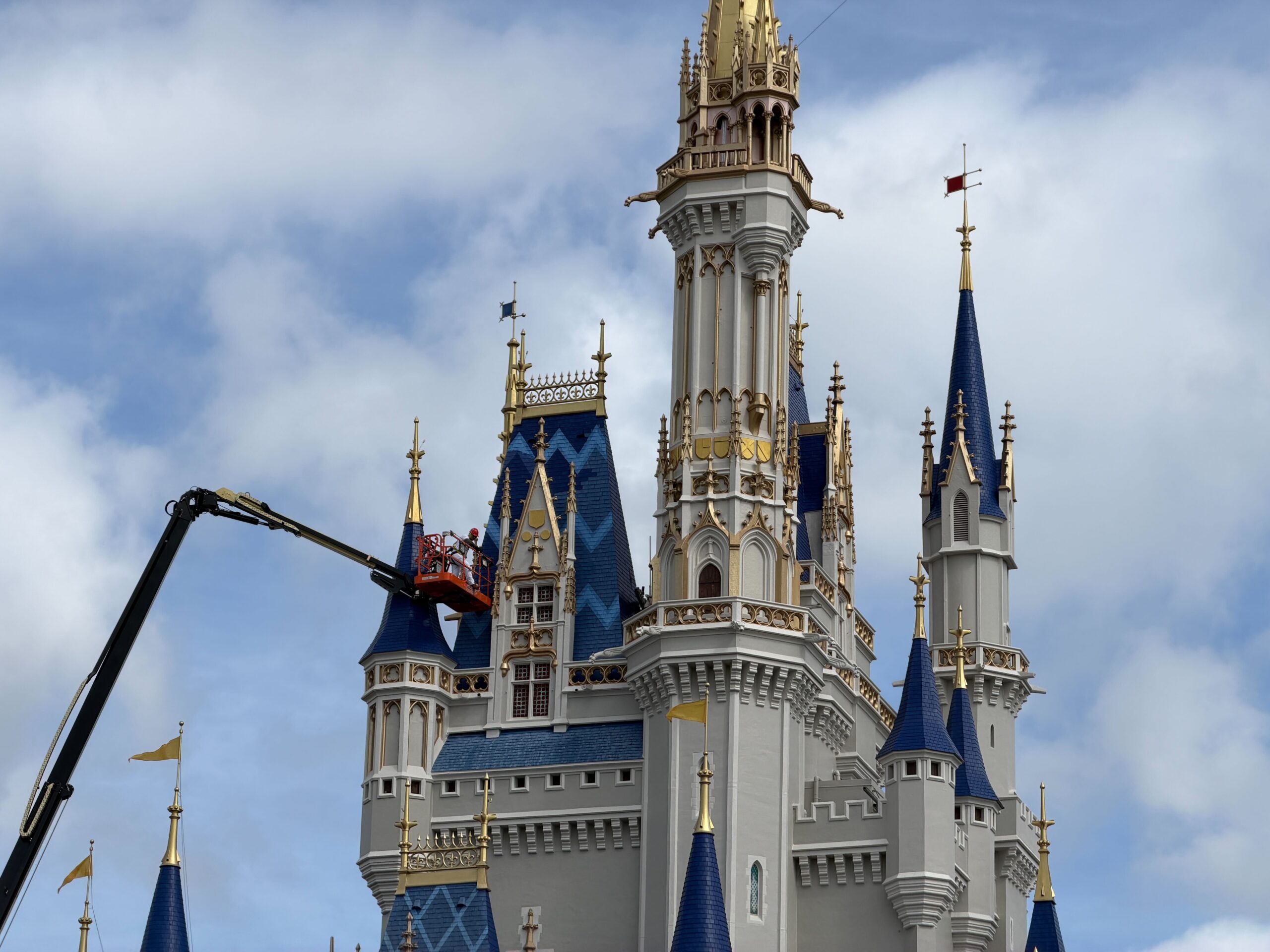 Crews continue to focus on the blue roofing of Cinderella Castle at Magic Kingdom, moving toward the blue towers with the patterns.