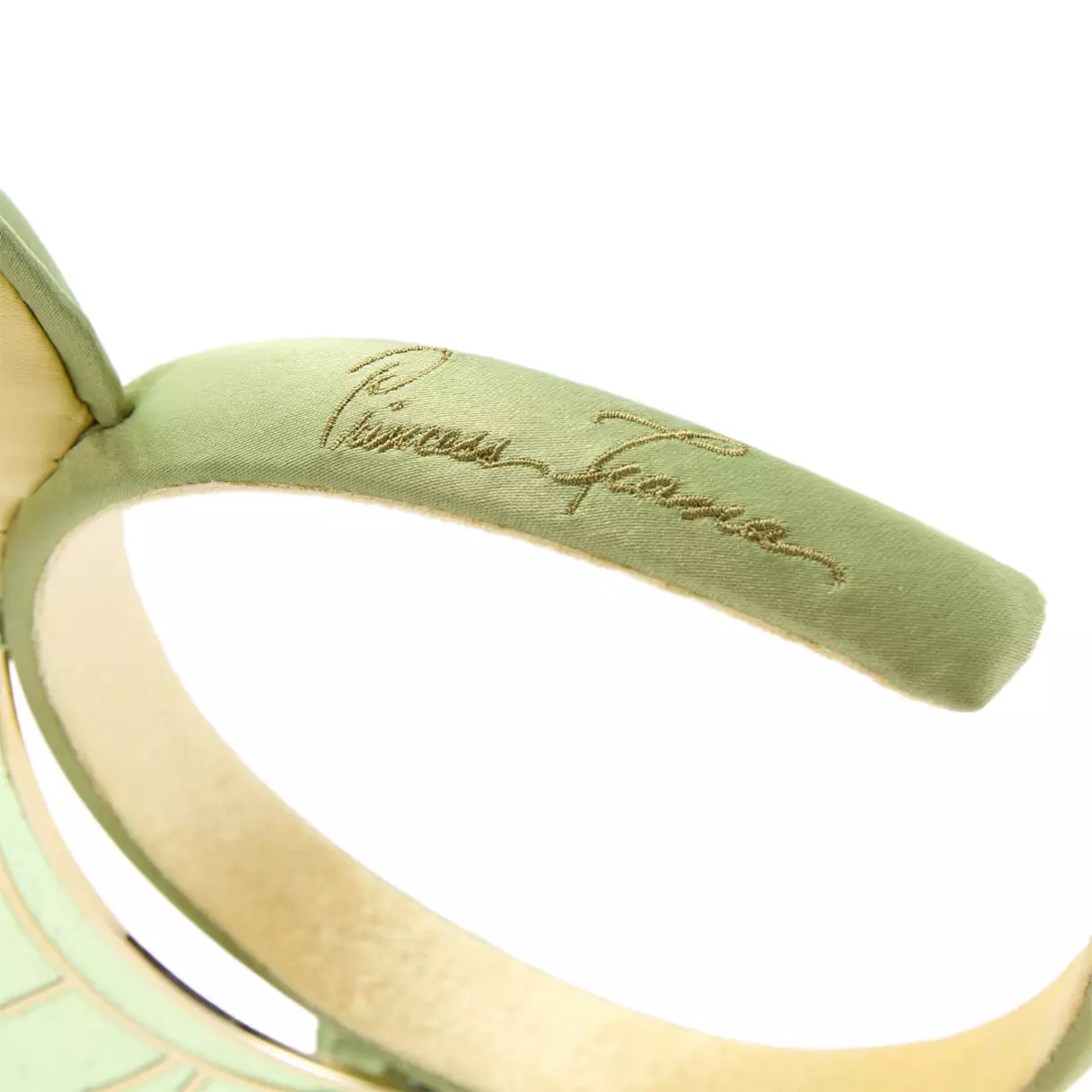 Princess Tiana's autograph is embroidered on the side of the headband.