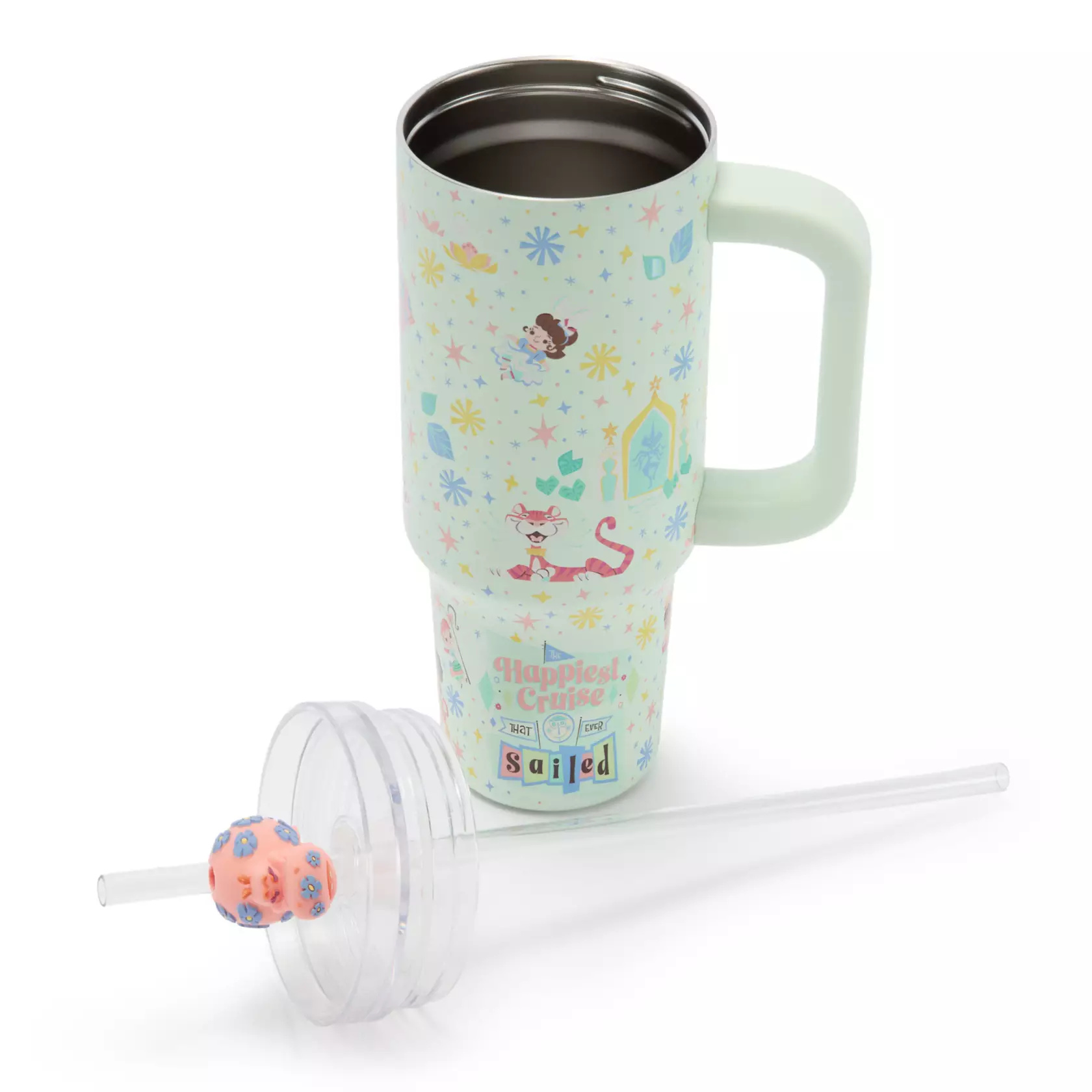 The tumbler is teal. It comes with a large accessory pouch on the front and a square handle. The tumbler has an all-over print with stars, trees, and children from the attraction. The bottom has “The happiest cruise that ever sailed” text.