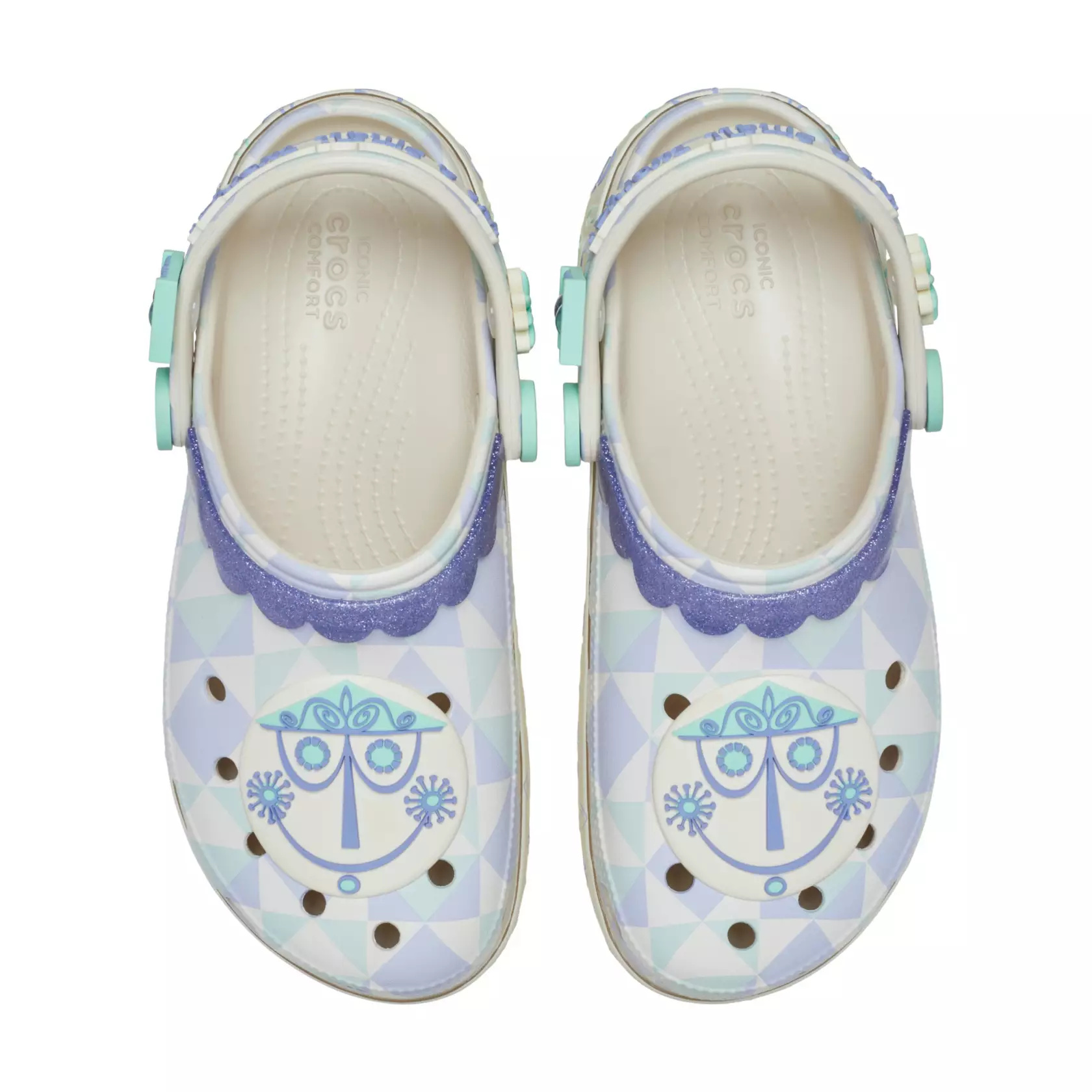 The clogs are covered in design patterns found on the attraction's facade. They are topped by clock face charms. Clock numerals are on the heels, and glittery purple faux lace trim lines the opening.