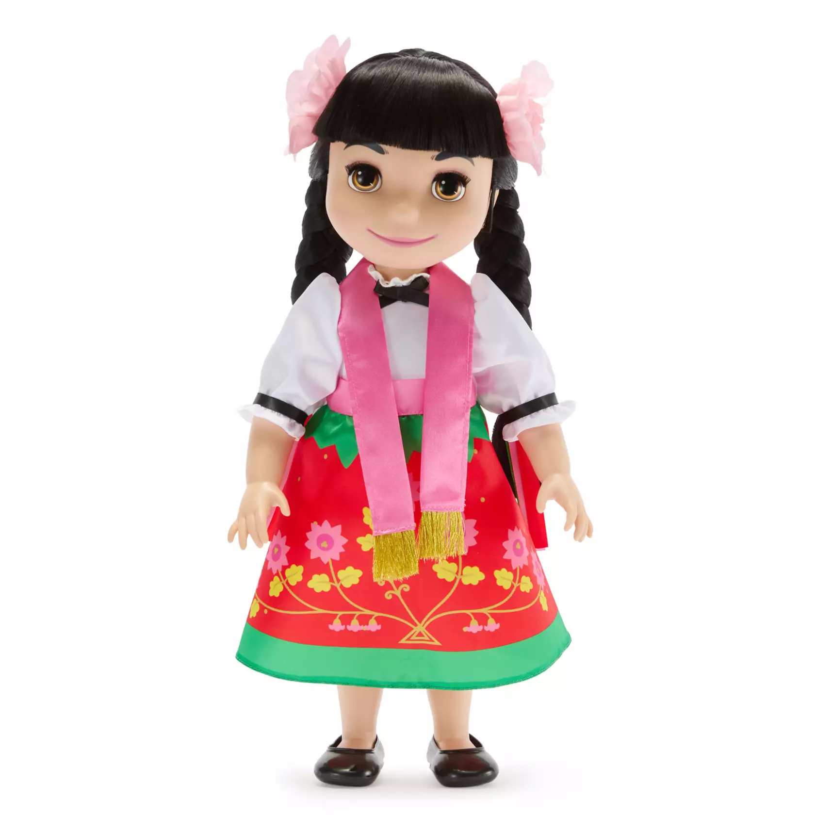 The 15" doll wears a traditional folk costume, which includes a multicolor floral print satin skirt, white top, and pink floral hair accessories. Press her tummy to hear the doll sing ''it's a small world'' in both Spanish and English. The On/Off switch is located on the doll's left side. It also comes in collector's display box.