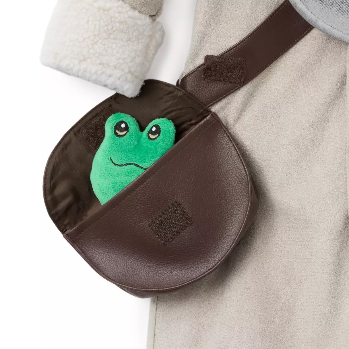 Little ones can become Grogu with this seven-piece set. It includes the beige robe, Grogu head hood, pouch, two mitts, and two booties. The hood has embroidered features and plush ears. The robe is made of soft faux suede with faux sherling trim. An embroidered mudhorn emblem is on the chest plate. Inside the pouch is a frog squeaker toy. The costume has Velcro closures and is mostly polyester with polyurethane.