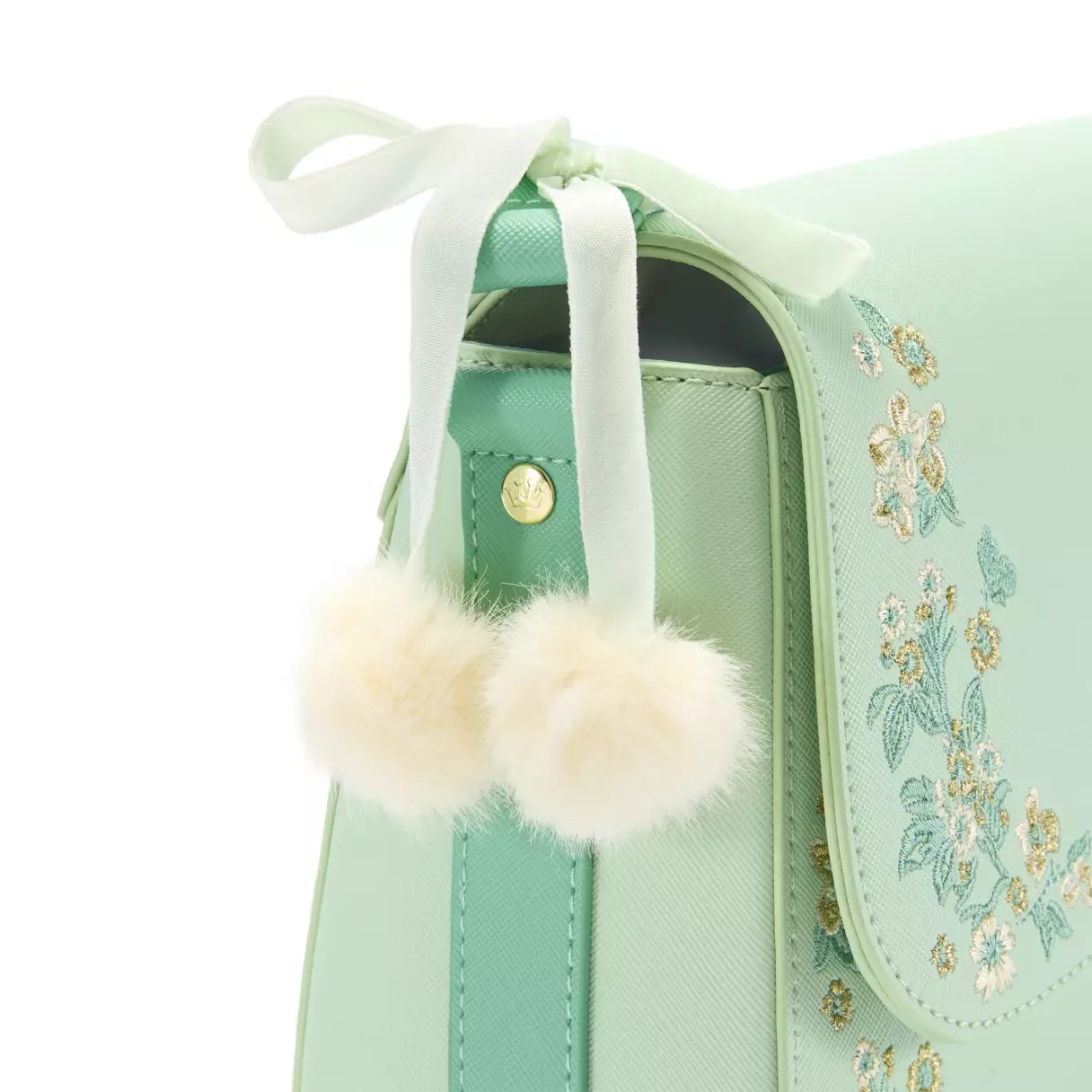 The bag is made of pale green textured simulated leather. The adjustable and removable strap is a brighter green. Embroidered floral and butterfly filigree is on the front and back of the bag.