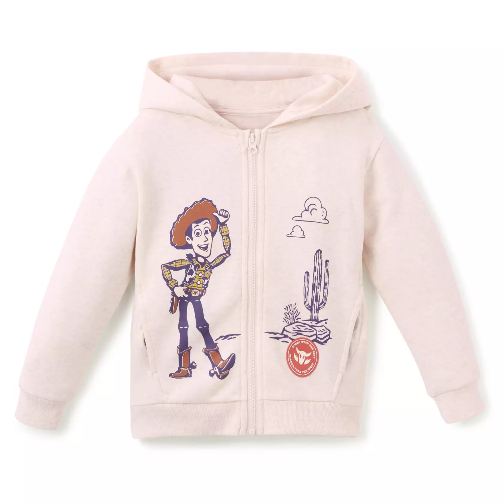 The cream-colored zip hoodie has front screen art of Woody posing in the desert. There is also a rubber patch appliqué with the phrases "Rodeo with the best" and "Wilder than the west." Its pocket lining features screen artwork of Bullseye and Rex.