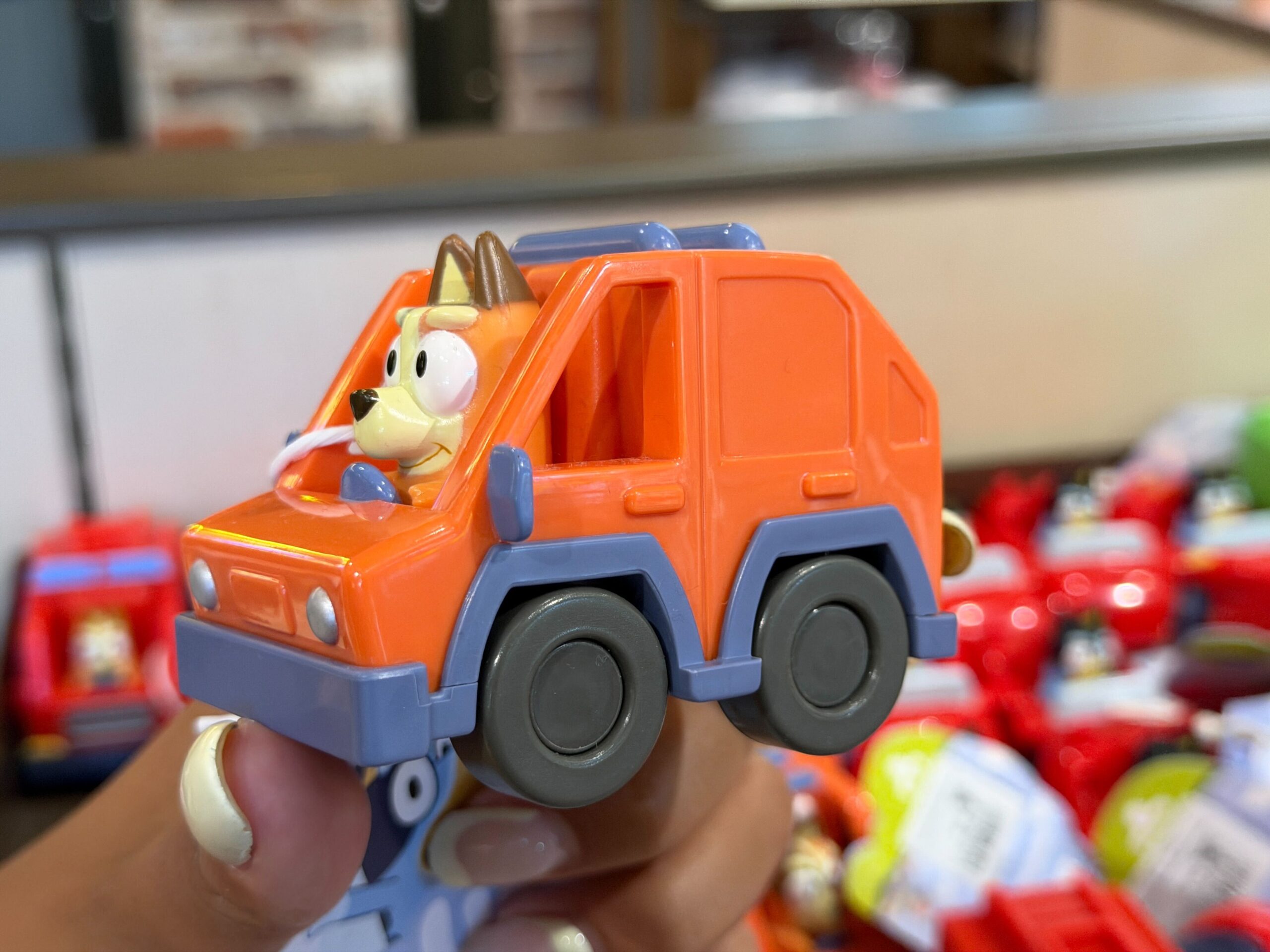 Bluey and Bingo's mom, Chilli, is driving the family's orange 4WD vehicle.