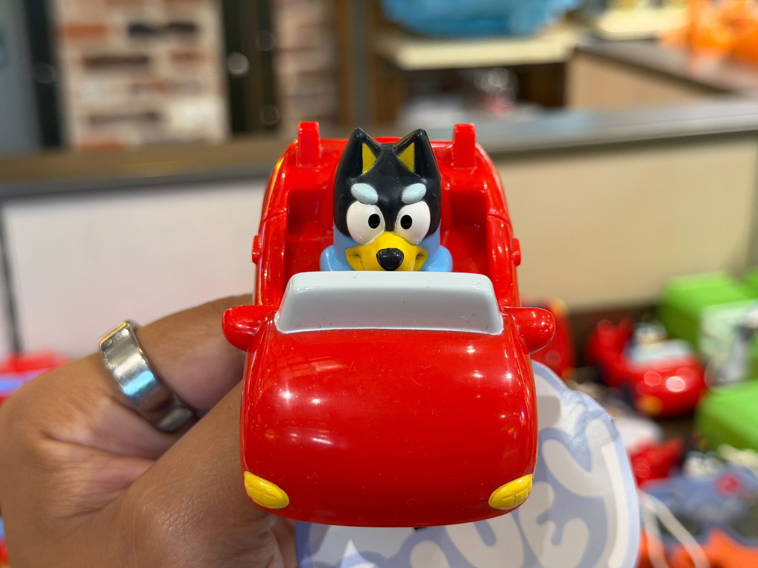 Dad Bandit is driving a red convertible sports car.