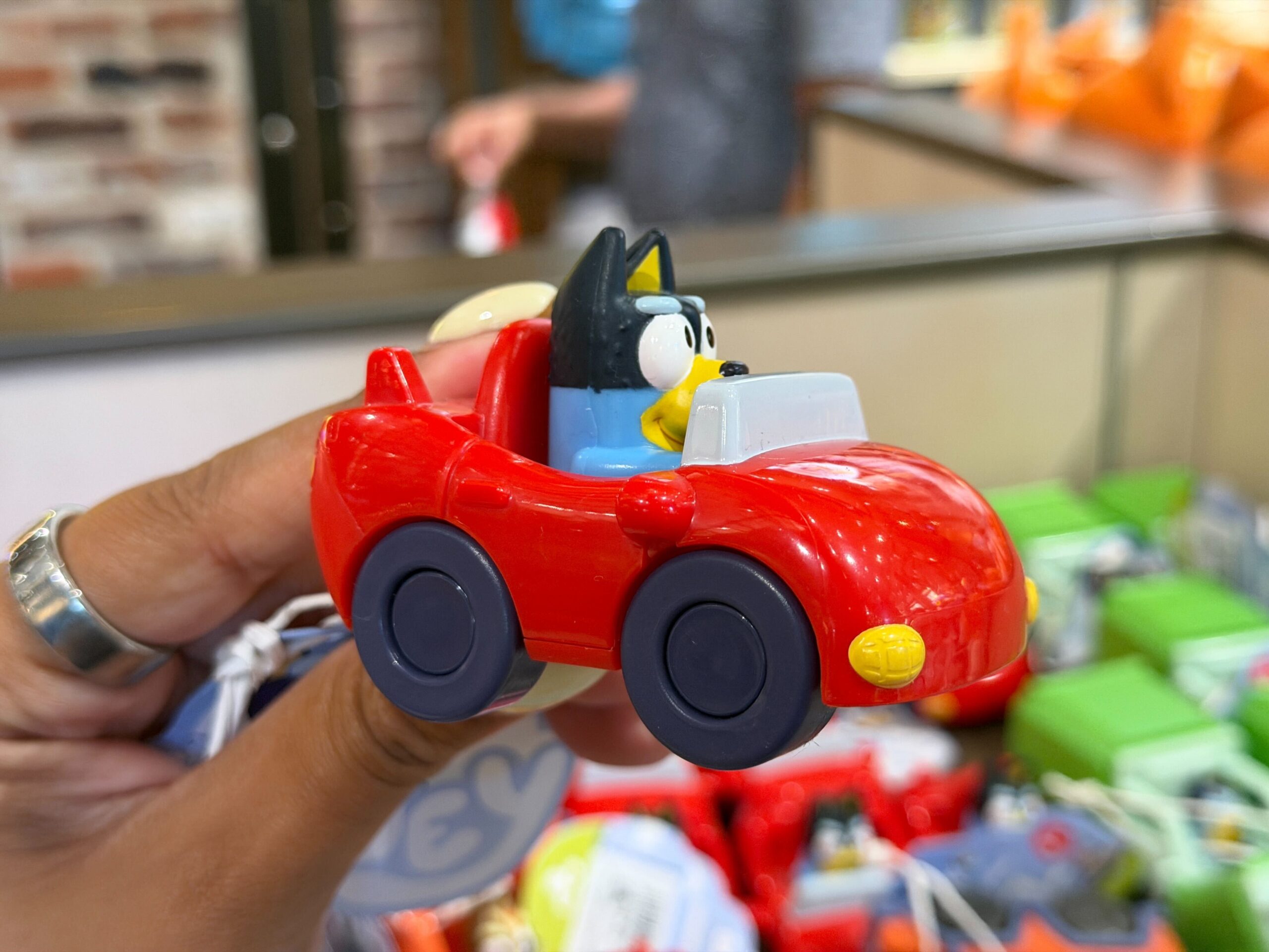 Dad Bandit is driving a red convertible sports car.