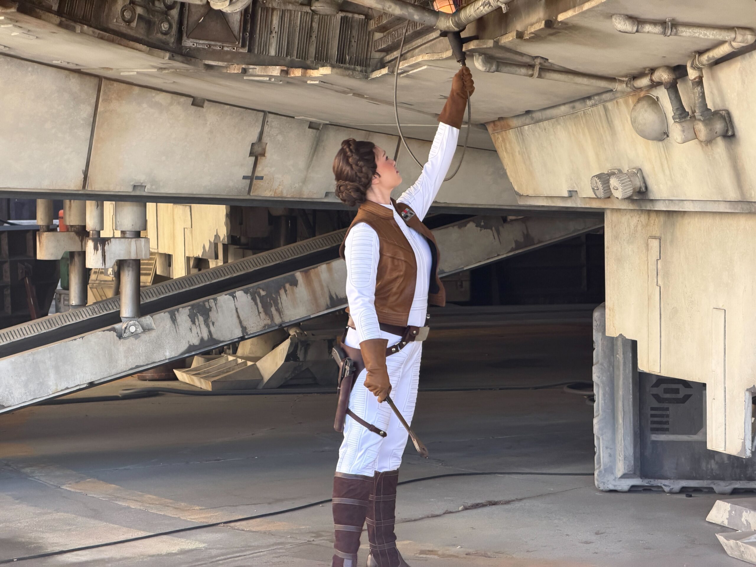Leia Organa fixes the Millennium Falcon at Disneyland