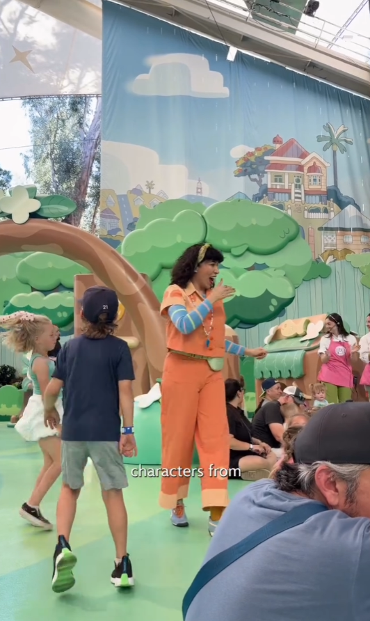 Human character in the show walking around, interacting with kids.