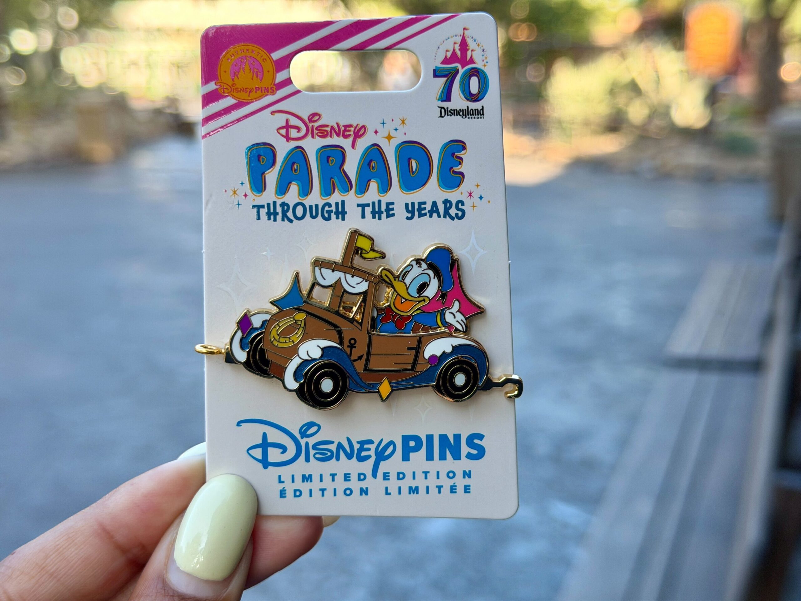 The 13th "Parade Through the Years" pin depicts Donald Duck behind the wheel of a ship-inspired parade float featuring sails and waves. This is limited edition of 2,000.