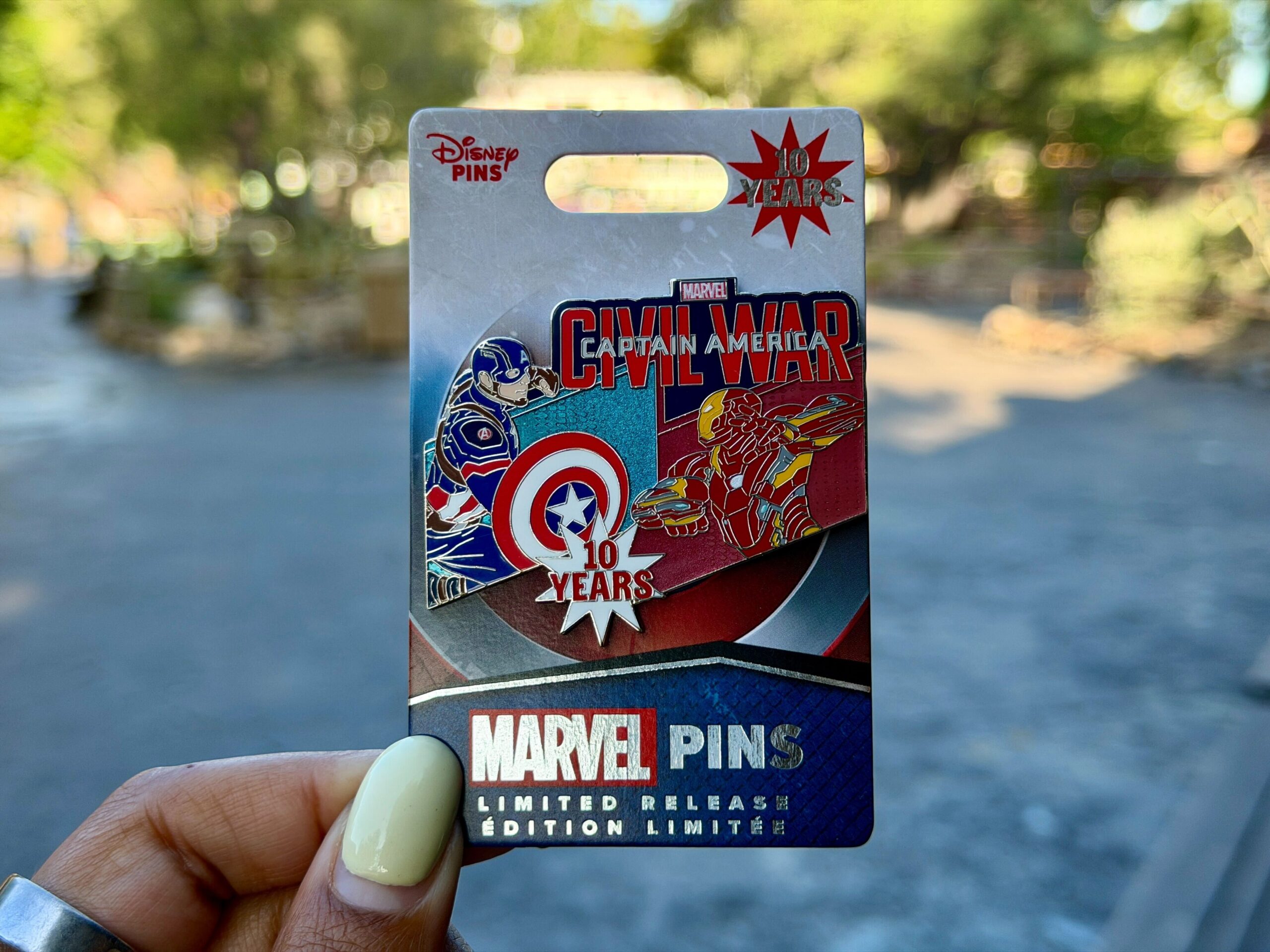 This pin features Iron Man and Captain America facing off with the Civil War logo above them. "10 Years" is on a starburst at the bottom of the pin.