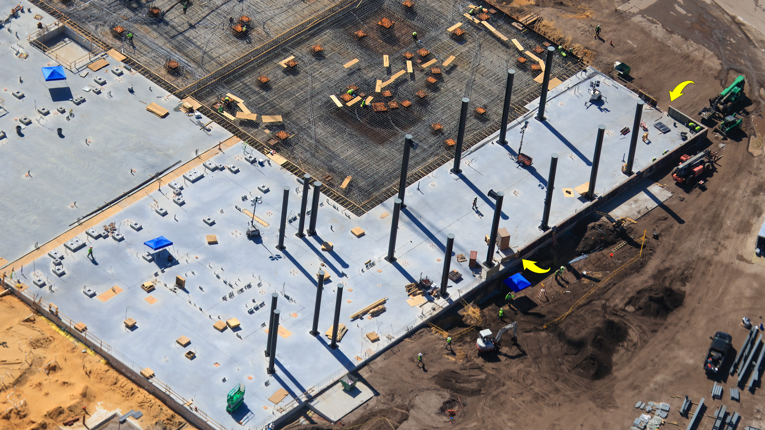 Over at the new roller coaster area, we see support columns being installed. Last week, we saw these columns staged nearby, and we suspect they are many of those columns. All around this freshly paved area, we see raised platforms and other installation areas, likely for more supports or other coaster elements in the near future.