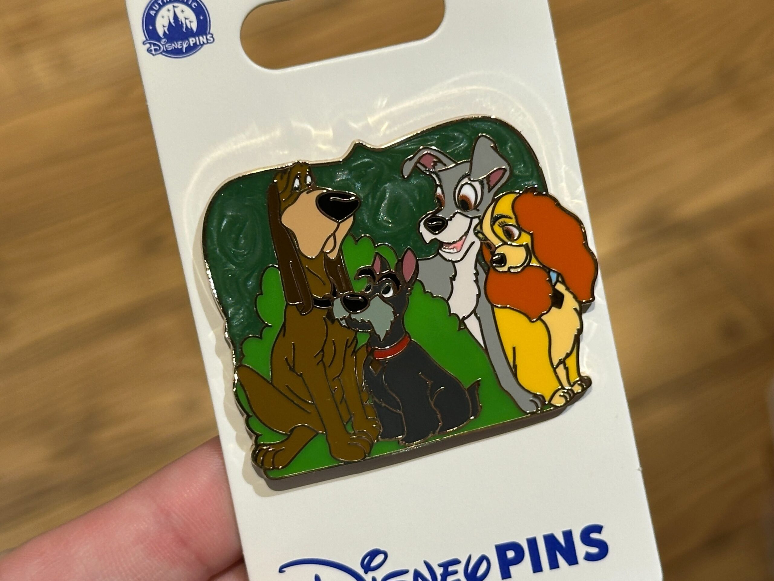 Lady, Tramp, Jock, and Trusty are on this pin among hedges.