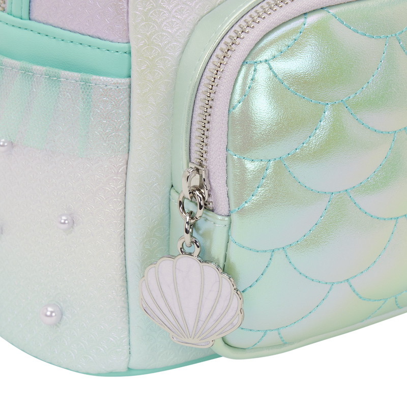 Another enamel seashell charm is on the front pocket's zipper. The side pockets have tulle trim inspired by Ariel's tail. Faux pearls dot the bag like bubbles.