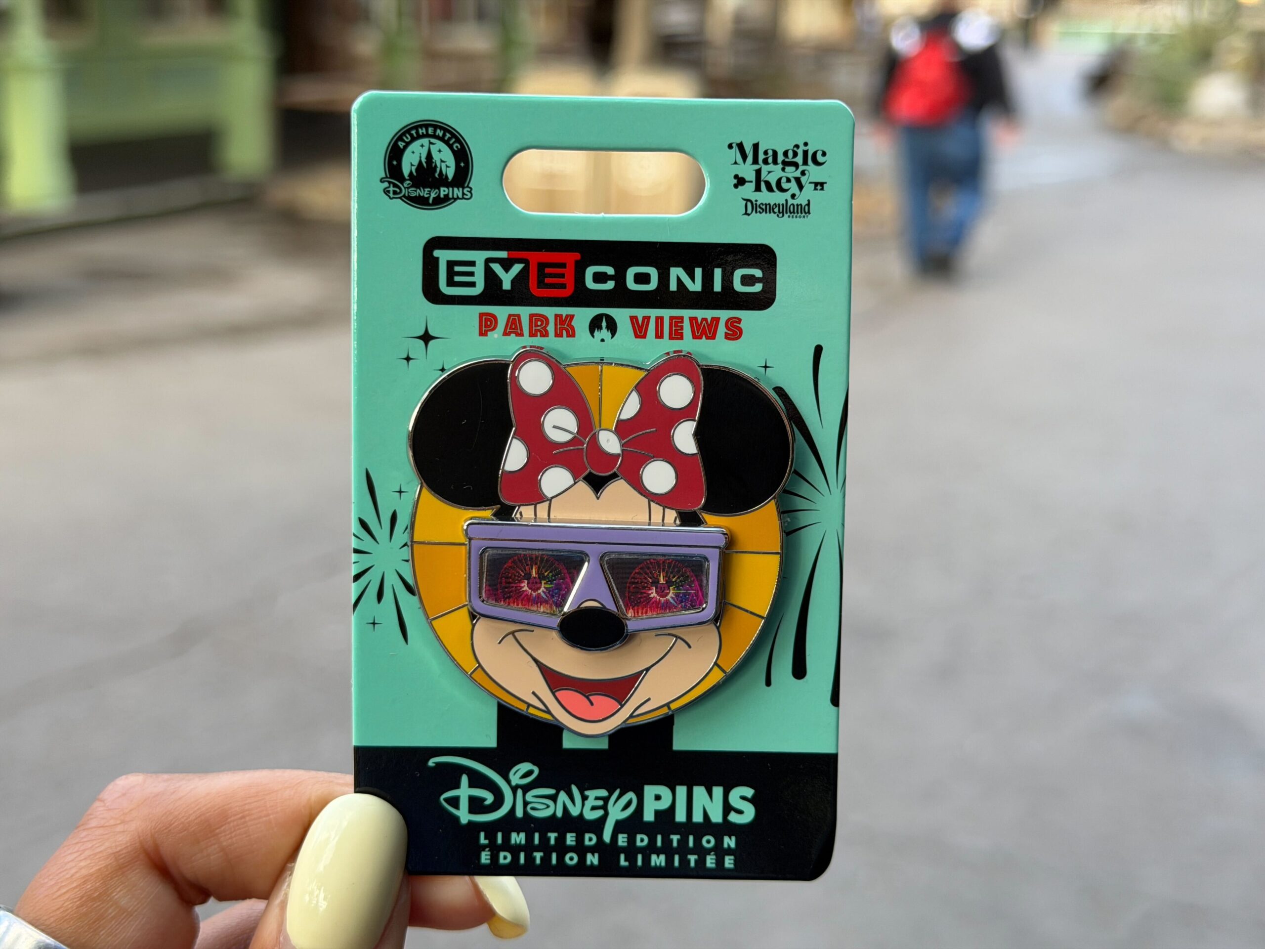 In this second quarterly Eyeconic Park Views pin release, we see Minnie wearing purple shades. The images in the sunglasses change depending on the angle. In one image, she is looking at the Pixar Pal-A-Round at Disney California Adventure, and in the other is the Carthay Circle Restaurant.