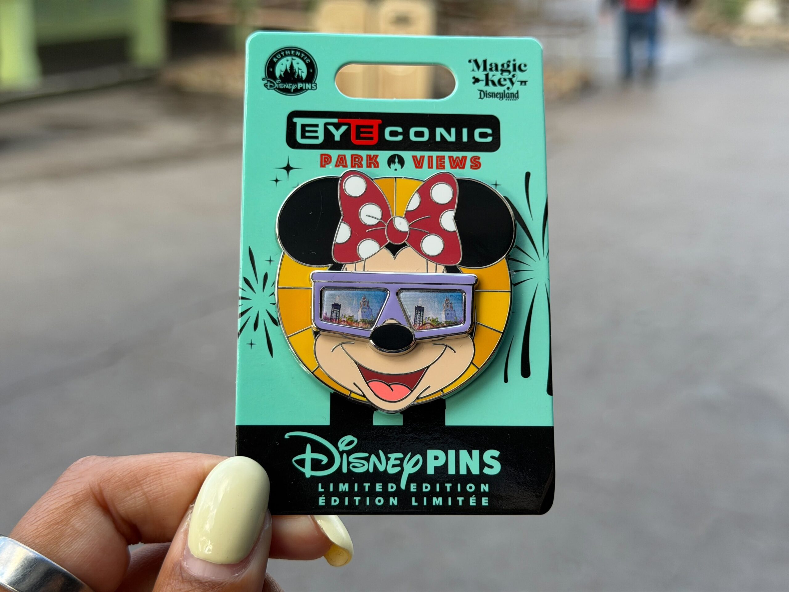 In this second quarterly Eyeconic Park Views pin release, we see Minnie wearing purple shades. The images in the sunglasses change depending on the angle. In one image, she is looking at the Pixar Pal-A-Round at Disney California Adventure, and in the other is the Carthay Circle Restaurant.