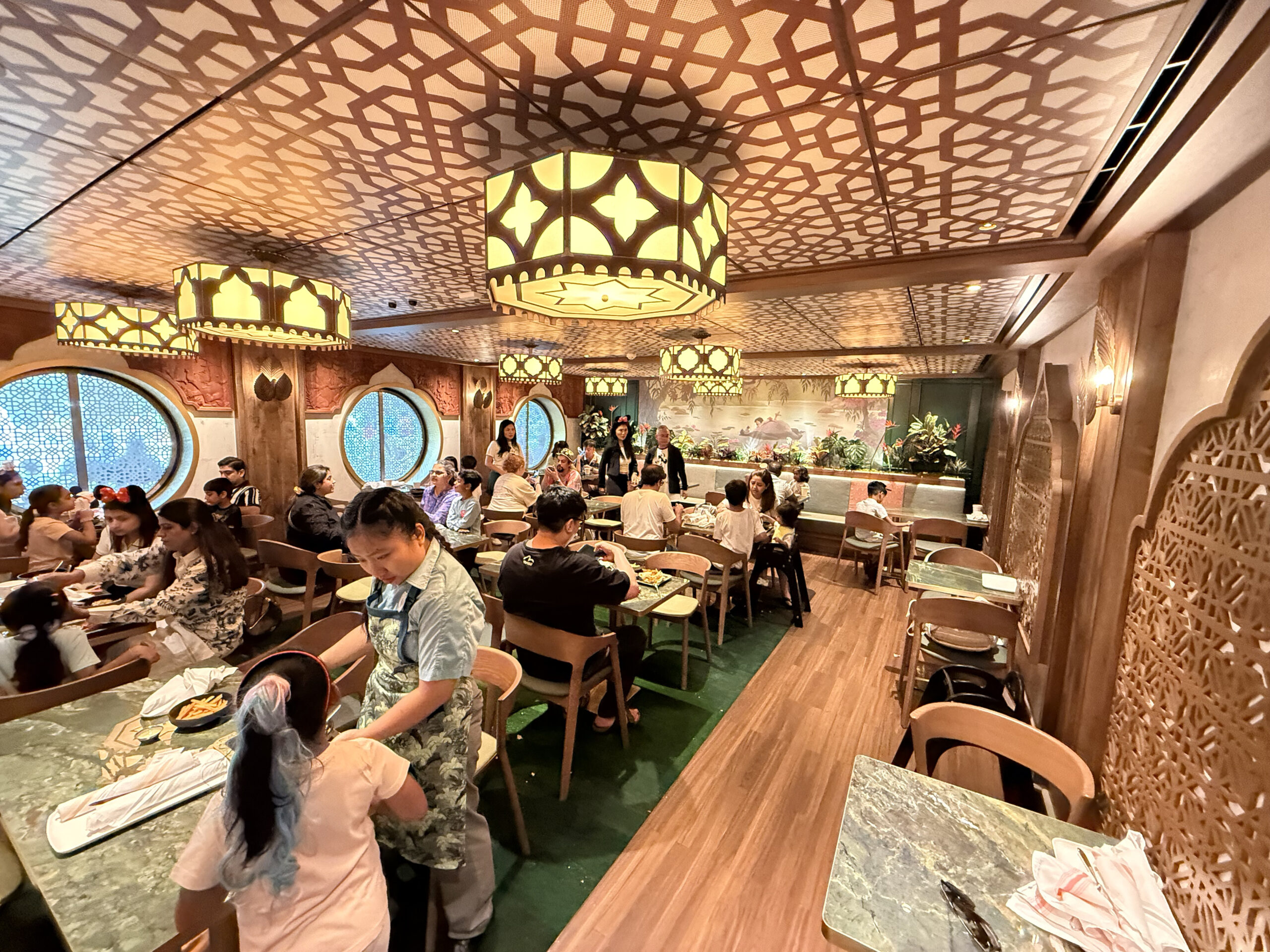 The seating area is a combination of about 20 two- and four- top tables. The flooring in here is mainly vinyl plank, but there is some green carpeting that mimics the jungle.