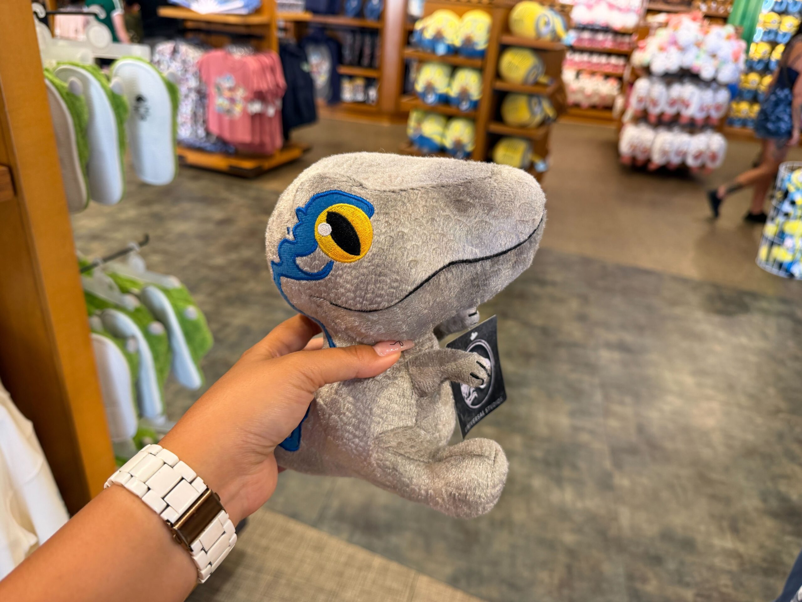 Each plush depicts a different species of dinosaur with a soft body, three-dimensional features, and embroidered eyes and mouths.