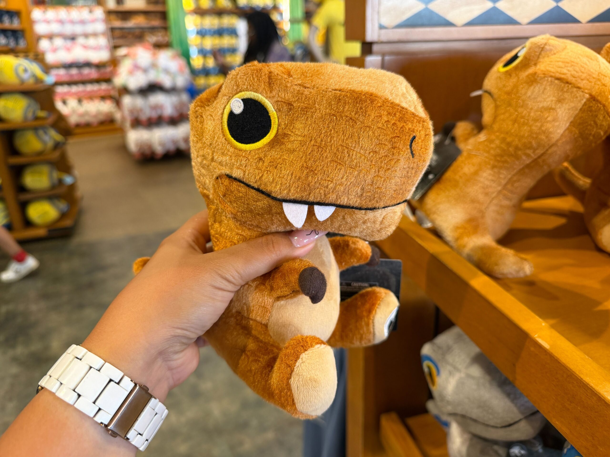 Each plush depicts a different species of dinosaur with a soft body, three-dimensional features, and embroidered eyes and mouths.