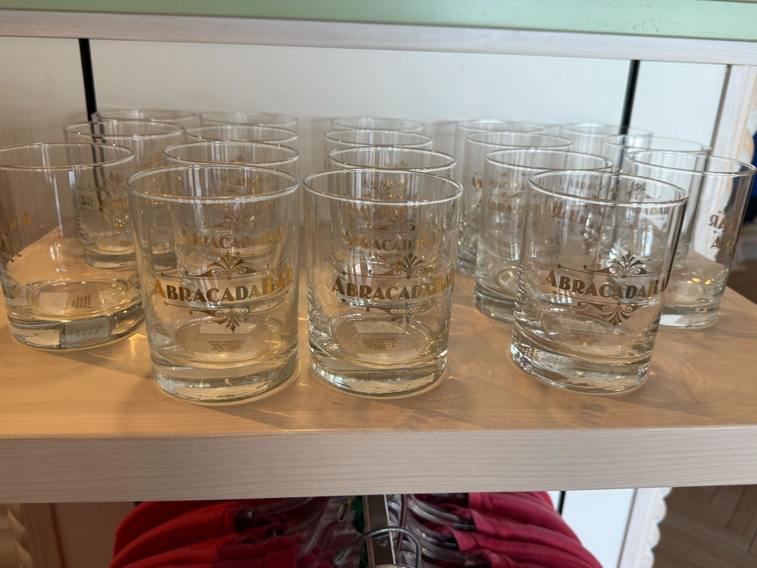 This shot glass features a simple wordmark of the Abracadabar with filigree on the top and bottom.