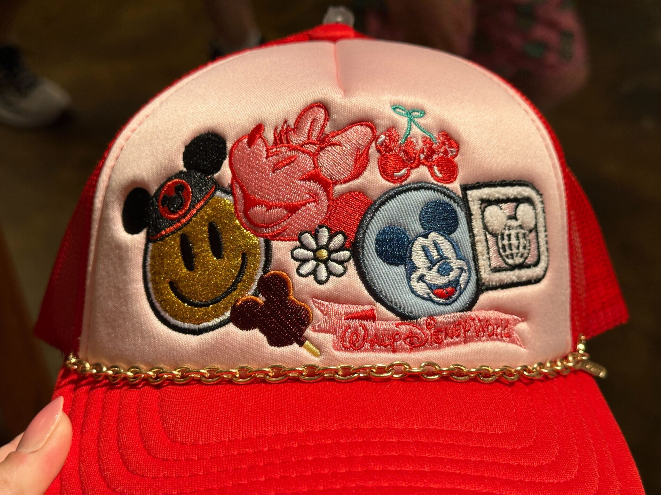 Close-up of front of Disney World Icons Red Trucker Hat.