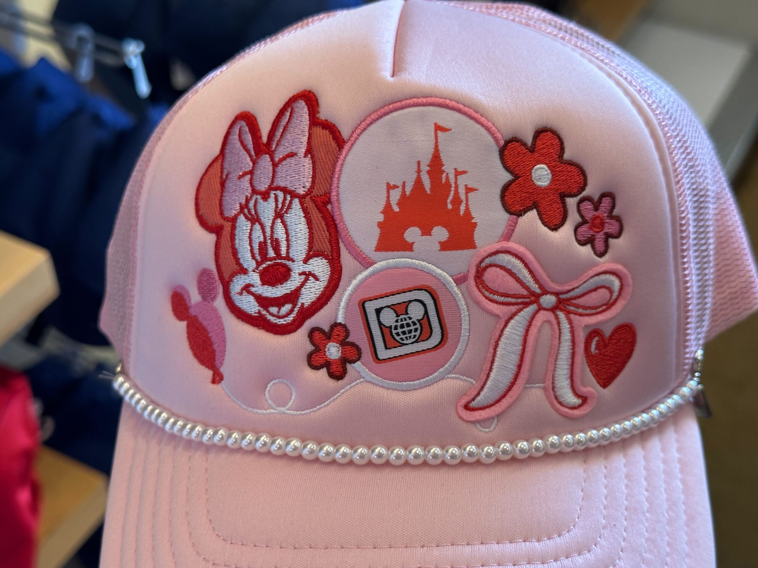 Close-up of front of Disney World Icons Pink Trucker Hat.