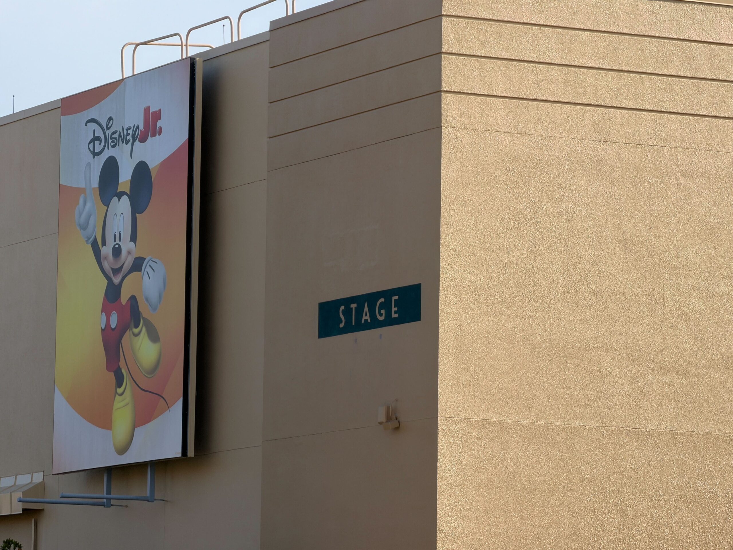 The Disney Jr. building now has a "Stage" sign painted near its corner. This is approximately where it once had a red "Stage 5" sign that matched other old Disney's Hollywood Studios signage. A number may be added to this new sign later.