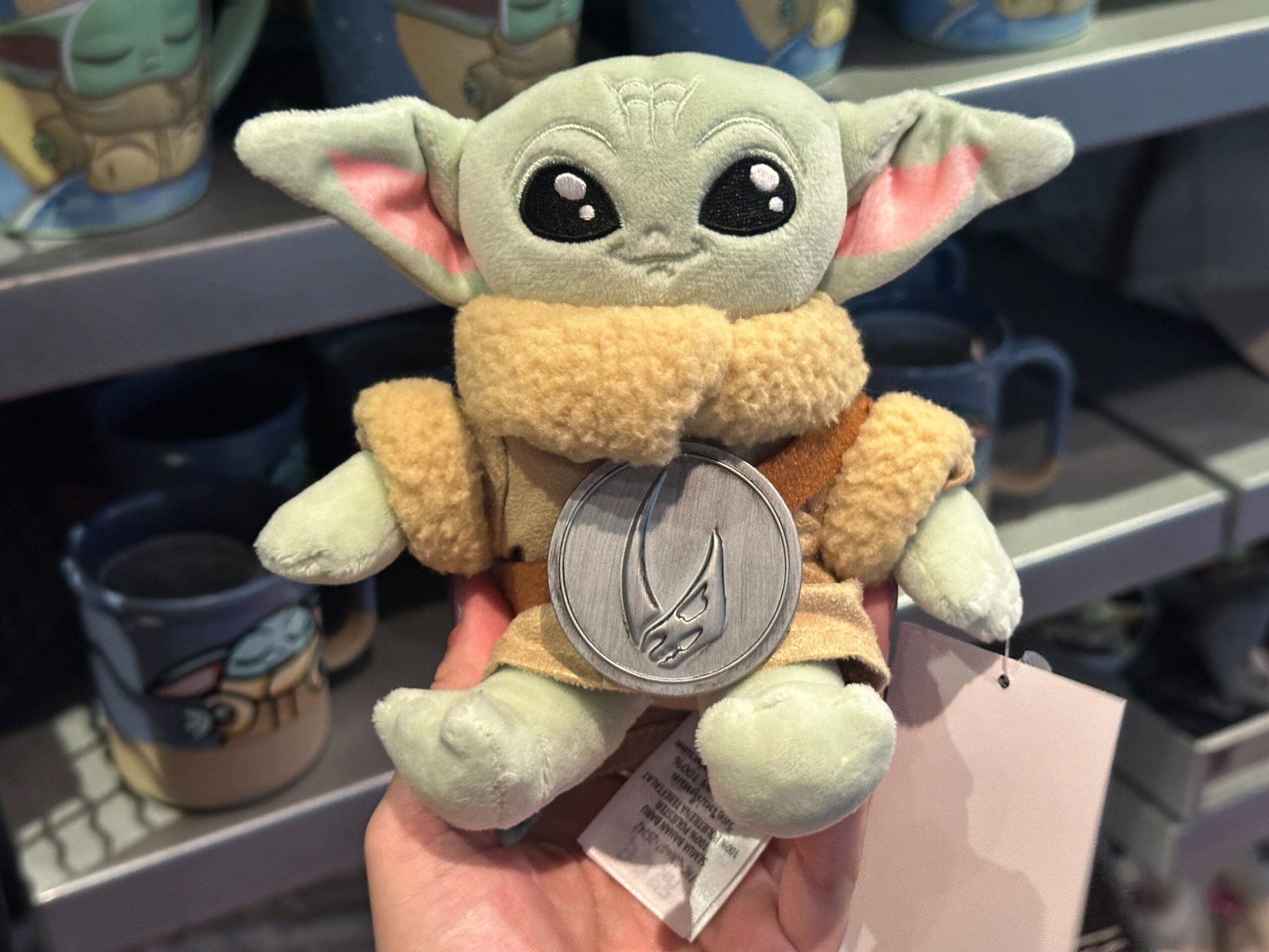 This new Grogu shoulder plush wears his mudhorn-branded beskar chest plate. He laughs when you press his head. The original Grogu shoulder plush was released in 2022.