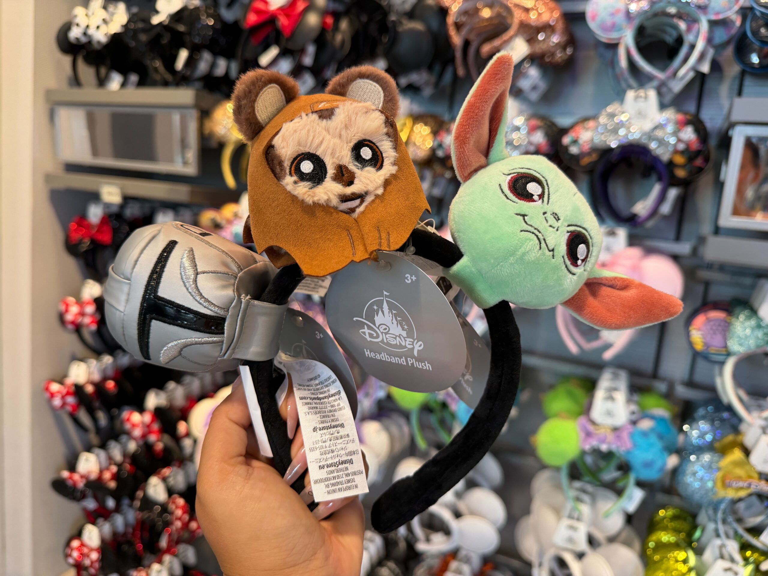 The Mandalorian and Grogu headband plush join previously released Ewok, Yoda, Darth Vader, R2-D2, and Stormtrooper plush. Bases are sold separately and include a black and blue headband, rainbow headband, and ball cap.