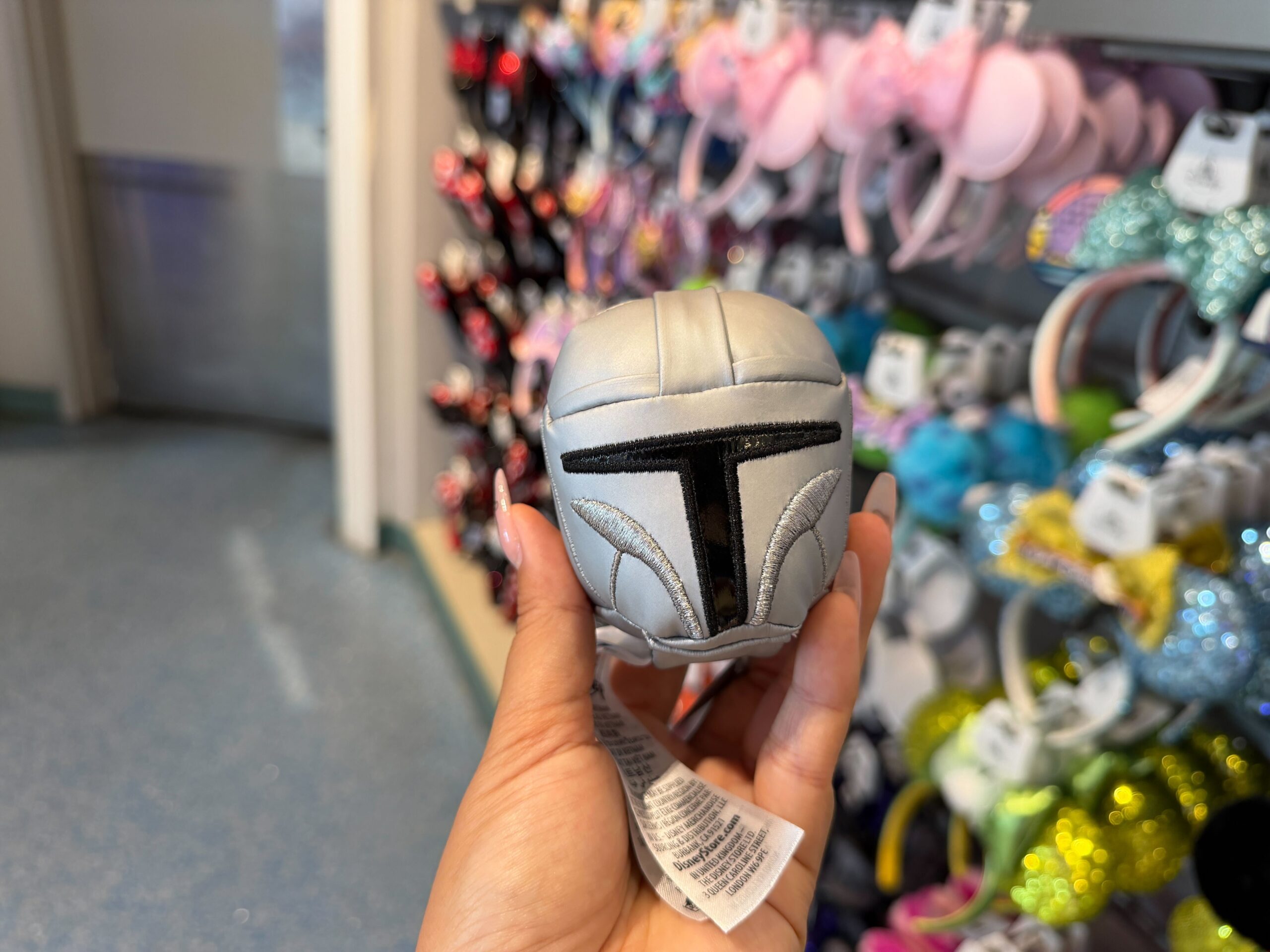 The Mandalorian plush accessory is in the shape and design of his helmet.