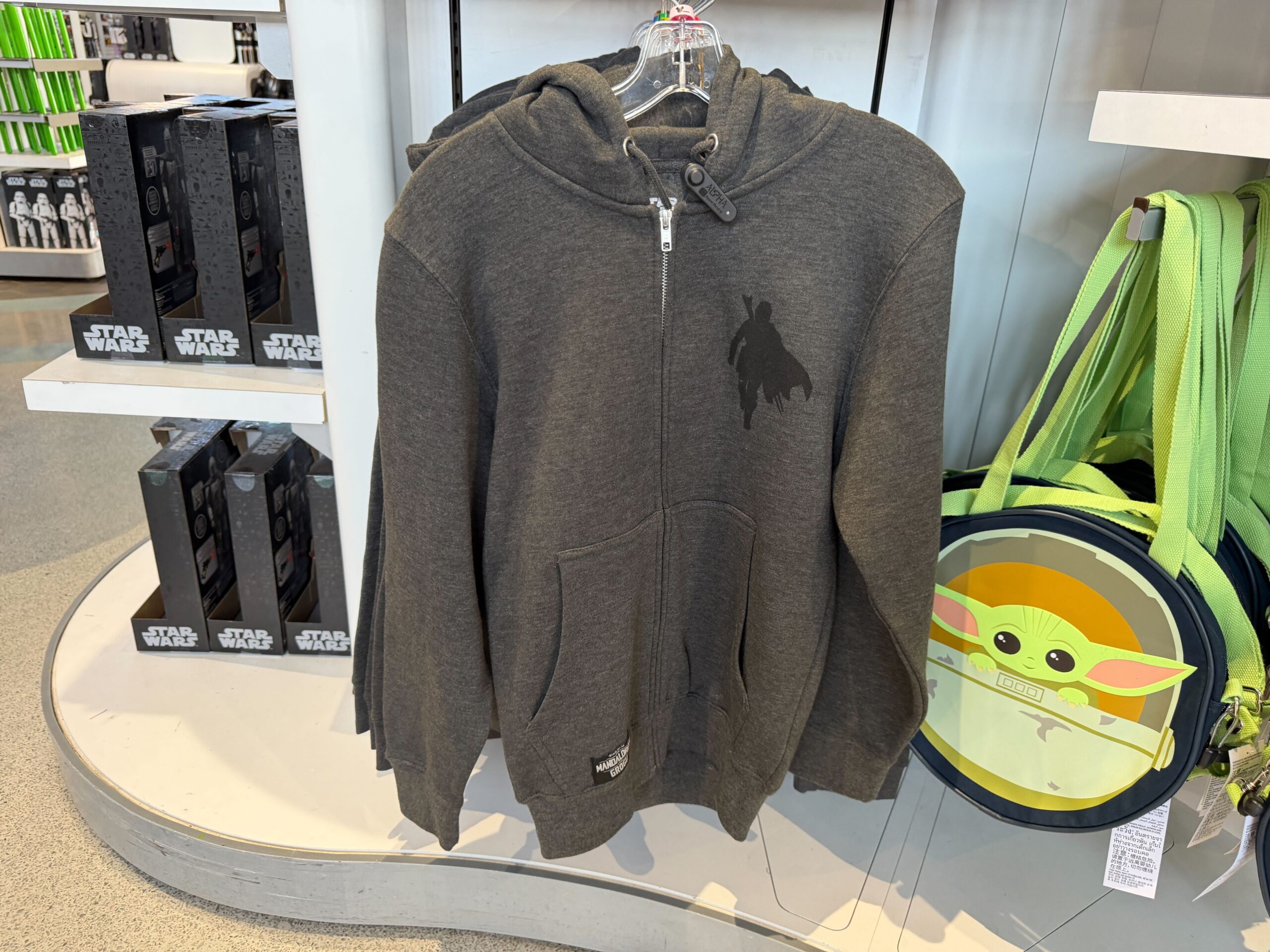 This is a dark heather gray hoodie. On the left chest is the silhouette of the Mandalorian with his cape.