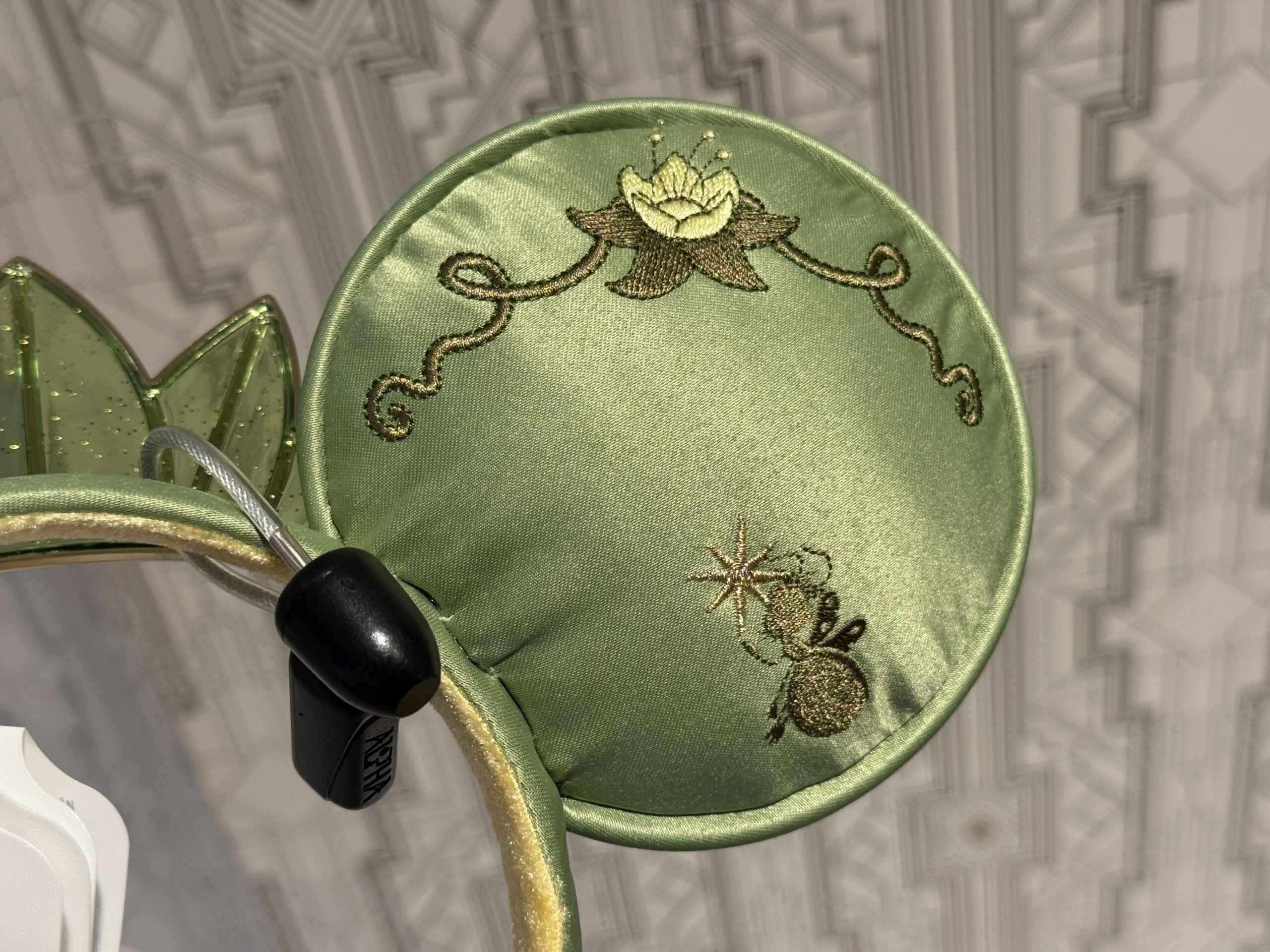 A new ear headband inspired by Princess Tiana's lily Pad dress from The Princess and the Frog has arrived at Walt Disney World.
