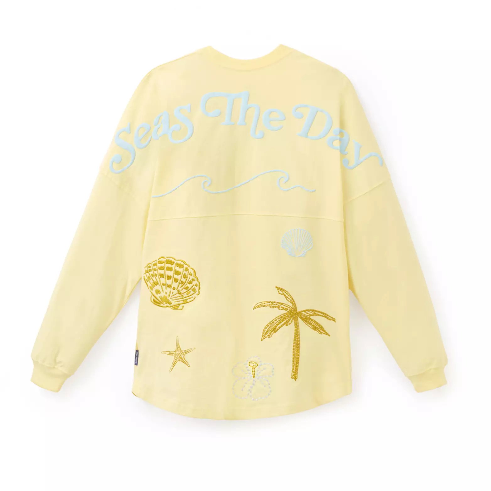 On the back, we see the same beachy iconography on the bottom half of the jersey. On the top, it reads "Seas the Day" in blue above an ocean wave outline.