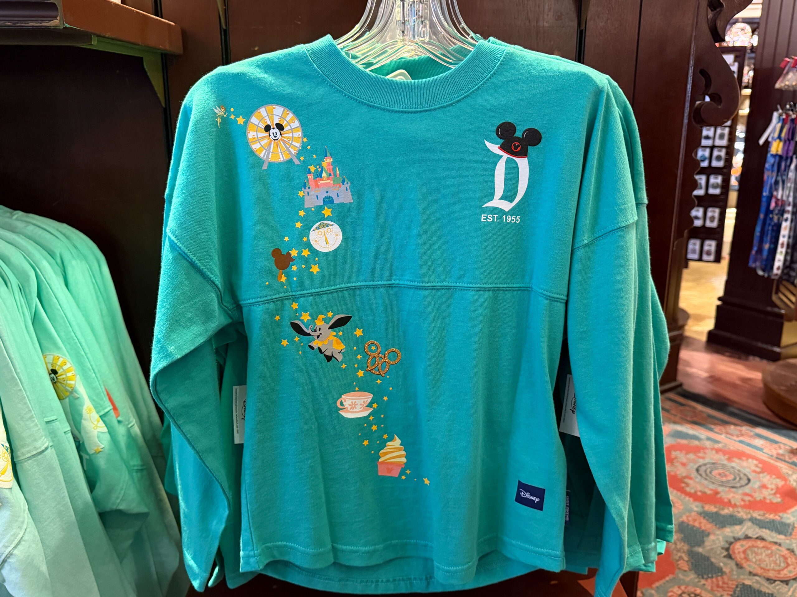 A new pair of Disneyland Spirit Jerseys has arrived at the resort, giving families a matching apparel option with a colorful park icon design.