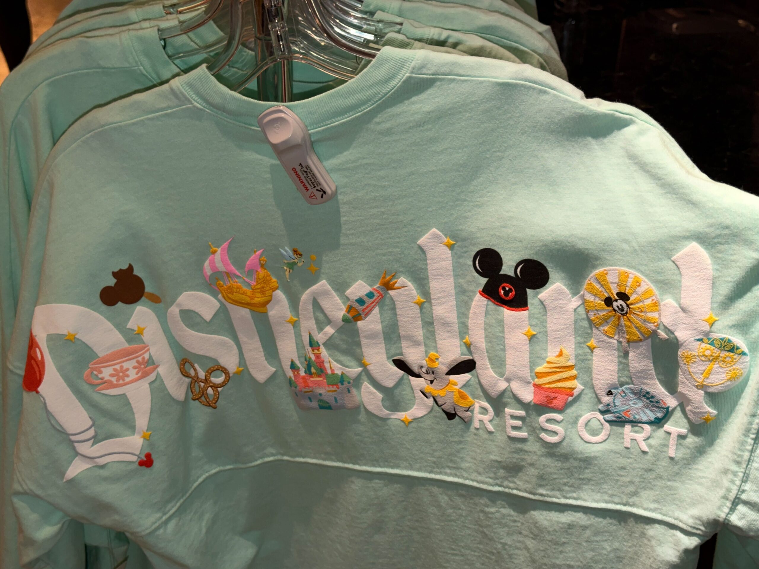 A new pair of Disneyland Spirit Jerseys has arrived at the resort, giving families a matching apparel option with a colorful park icon design.