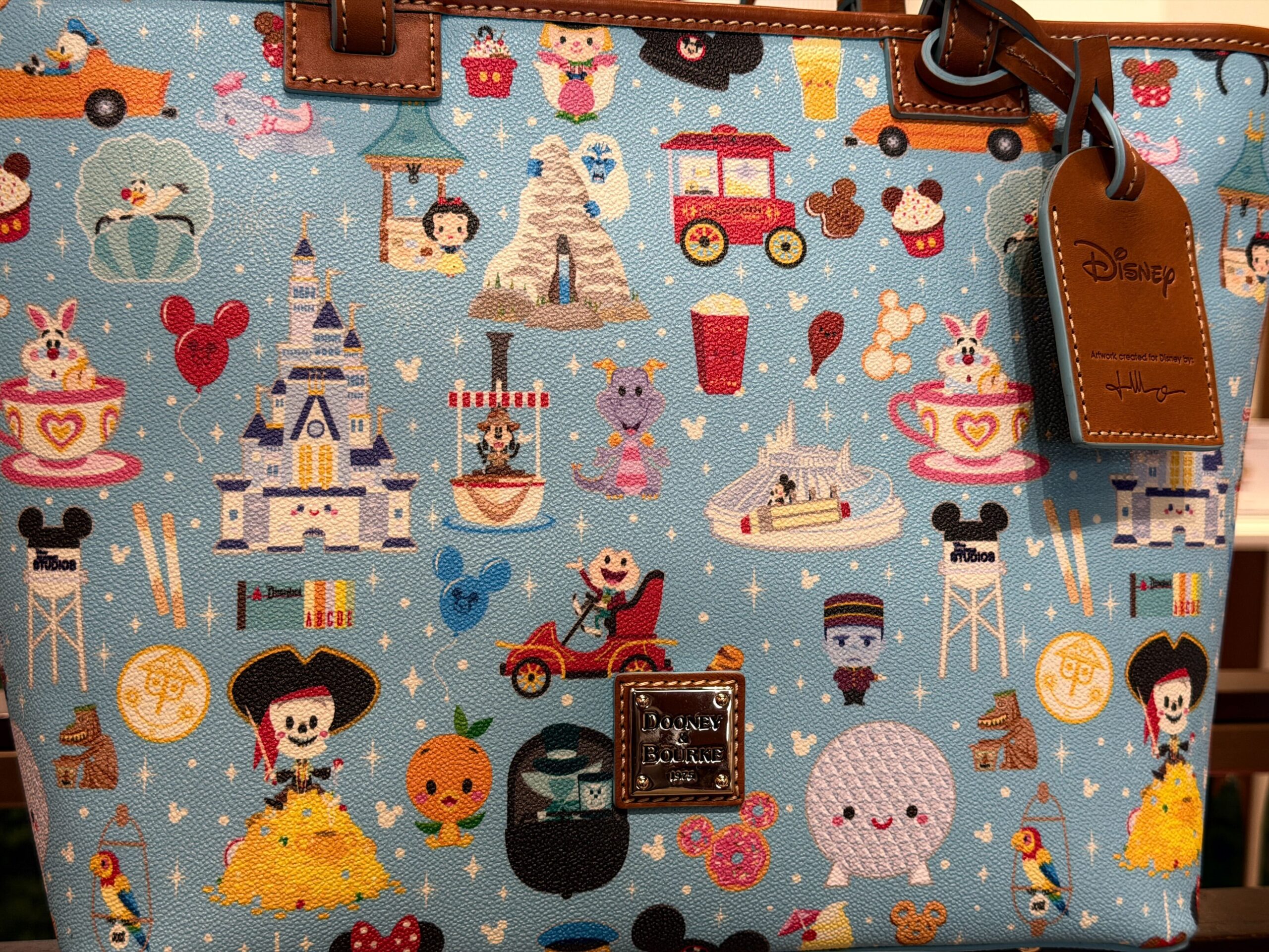 A new Dooney & Bourke bag has arrived with a tiny all-over Disney Parks print that demands a closer look.