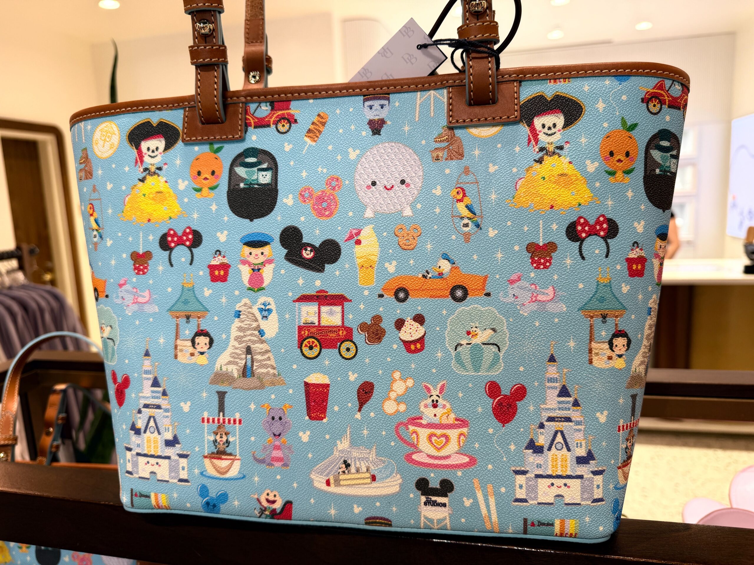 A new Dooney & Bourke bag has arrived with a tiny all-over Disney Parks print that demands a closer look.